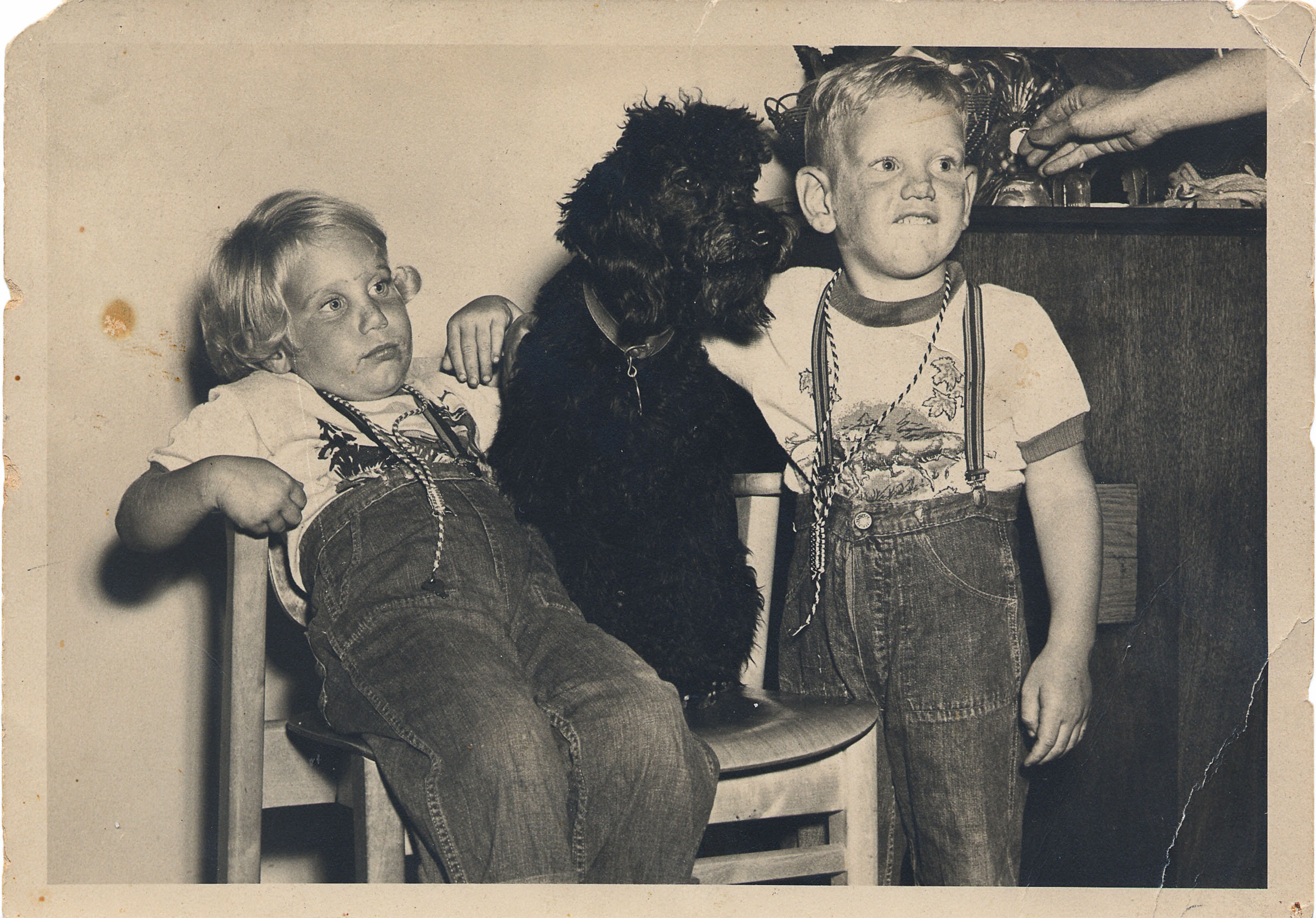A vintage photograph of Ray Benson and his sister Sandy Katz slouching in a chair