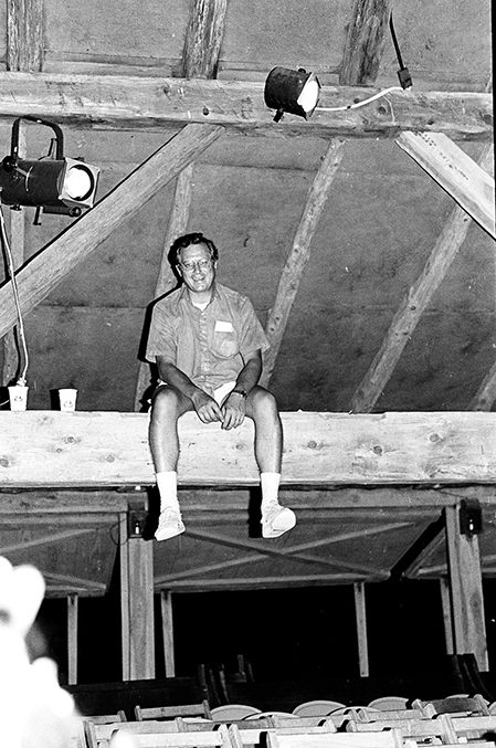 Photo of man on rafters in a barn