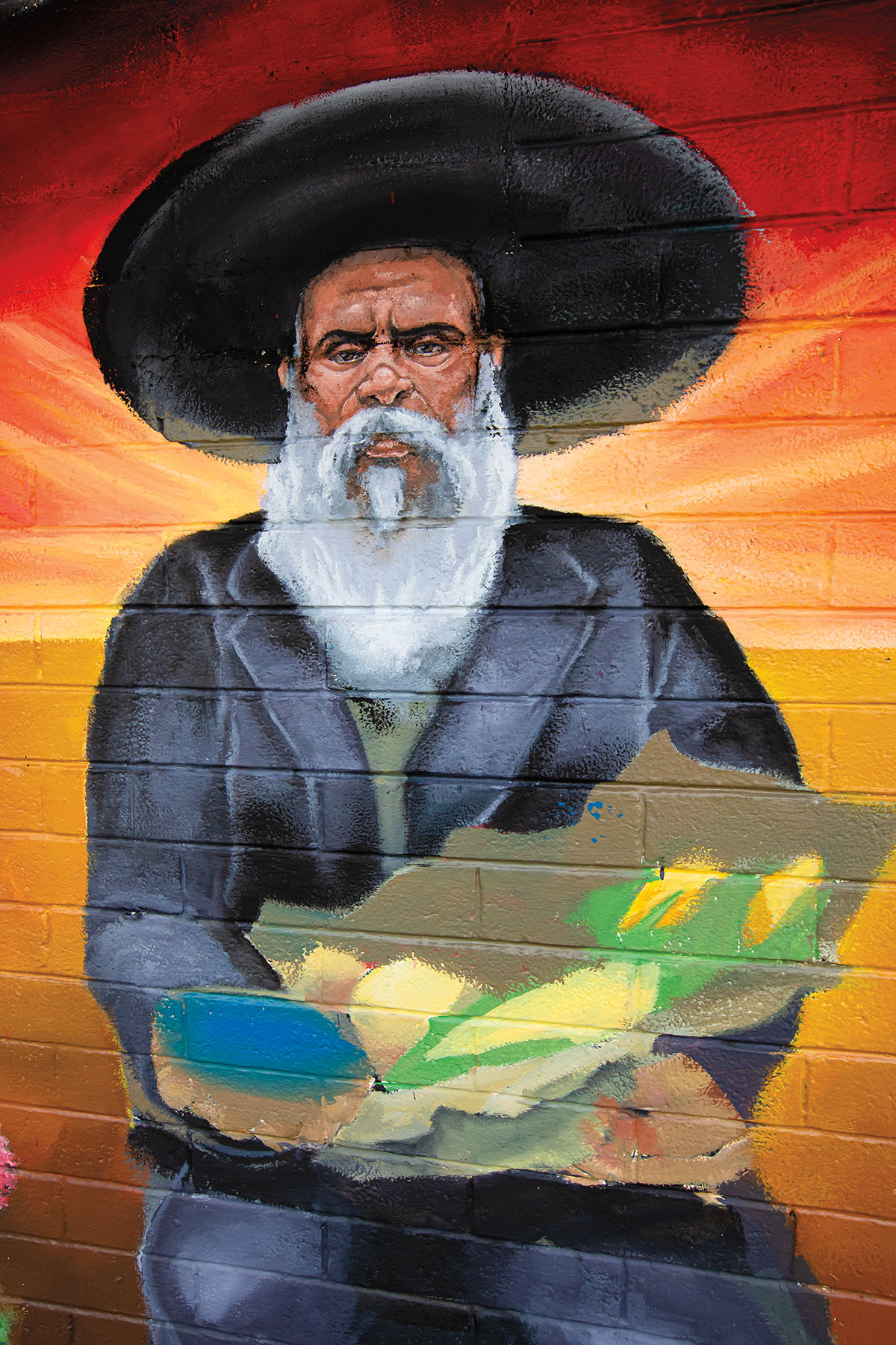 A mural of Don Pedro Jaramillo holding a vegetables