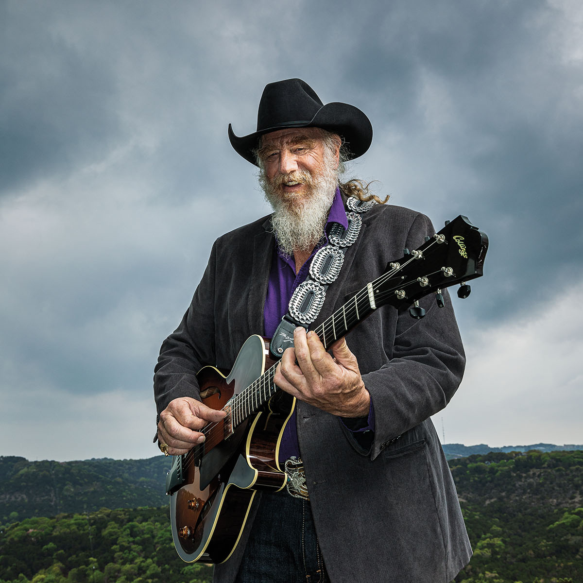 Ray Benson poses with a guitar near his home outside of Austin Texas
