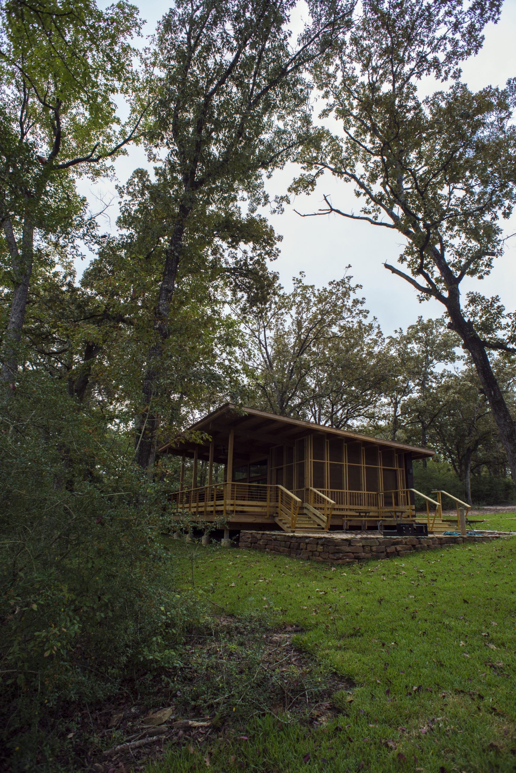 A cabin sits among the trees and greenery of Fort Boggy State Park