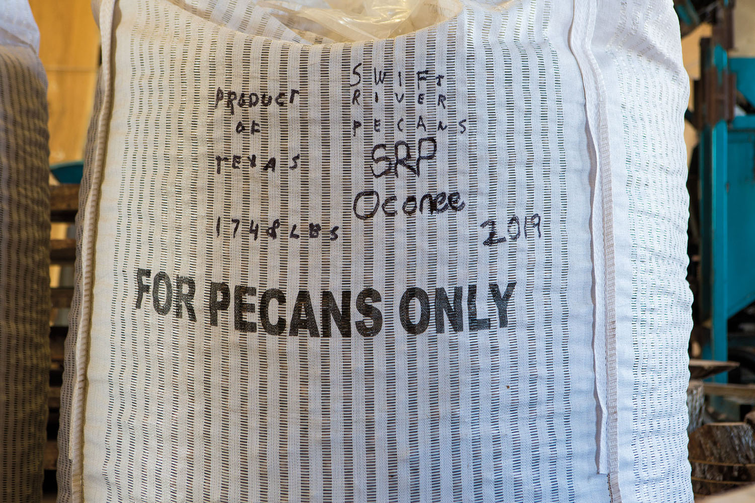 A white bag labeled "FOR PECANS ONLY"