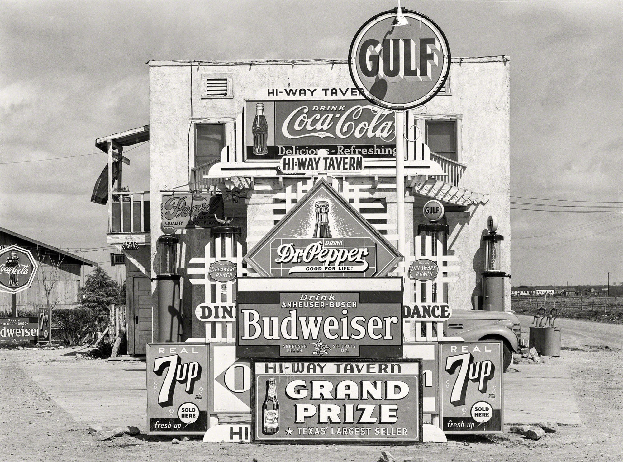 Beverage signs at a Gulf store, including Coca-Cola, Dr. Pepper, Budweiser and 7 Up