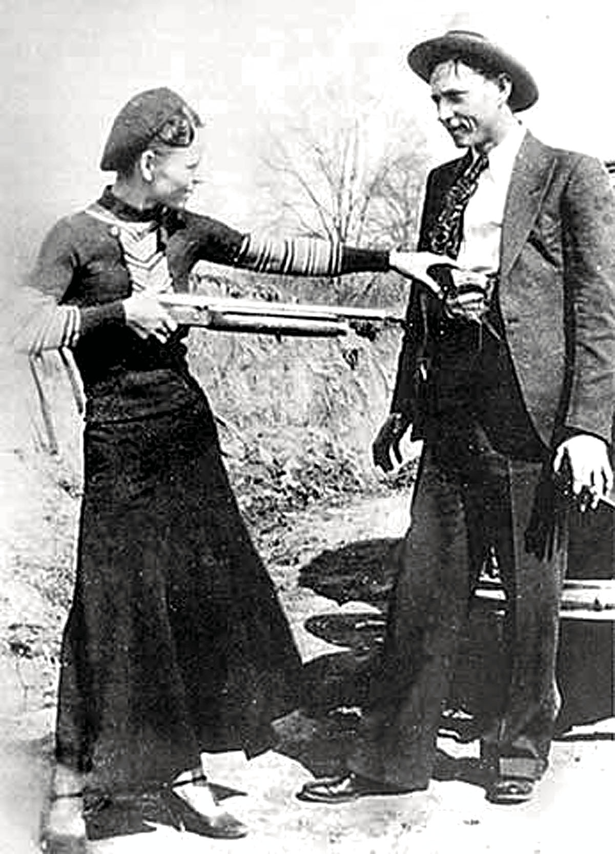 Bonnie holds Clyde at gunpoint while joking around for the camera in 1933