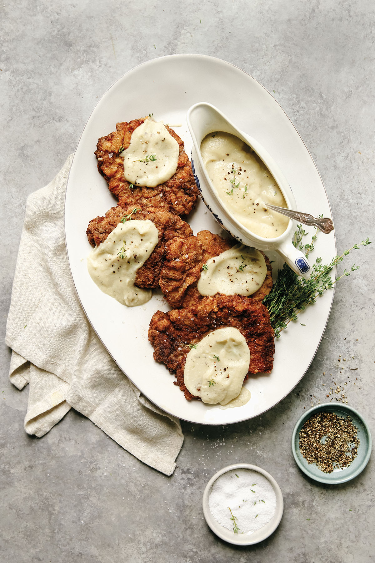 An aerial photo of chicken fried steak with cauliflower gravy on a platter