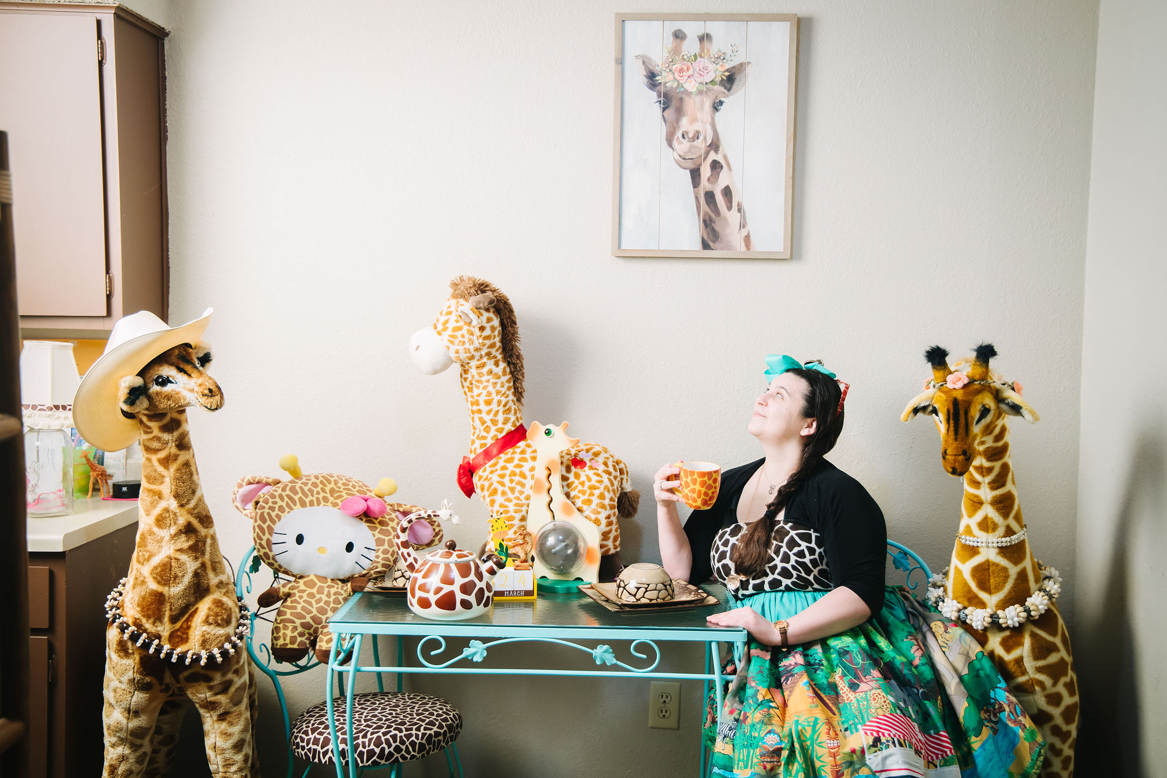 Autumn Circé surrounded by her giraffe collection.