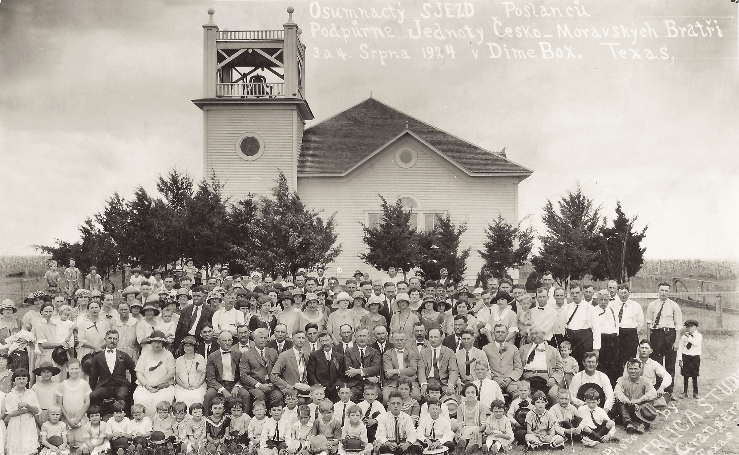 The newly rebuilt church with the congregation standing out front