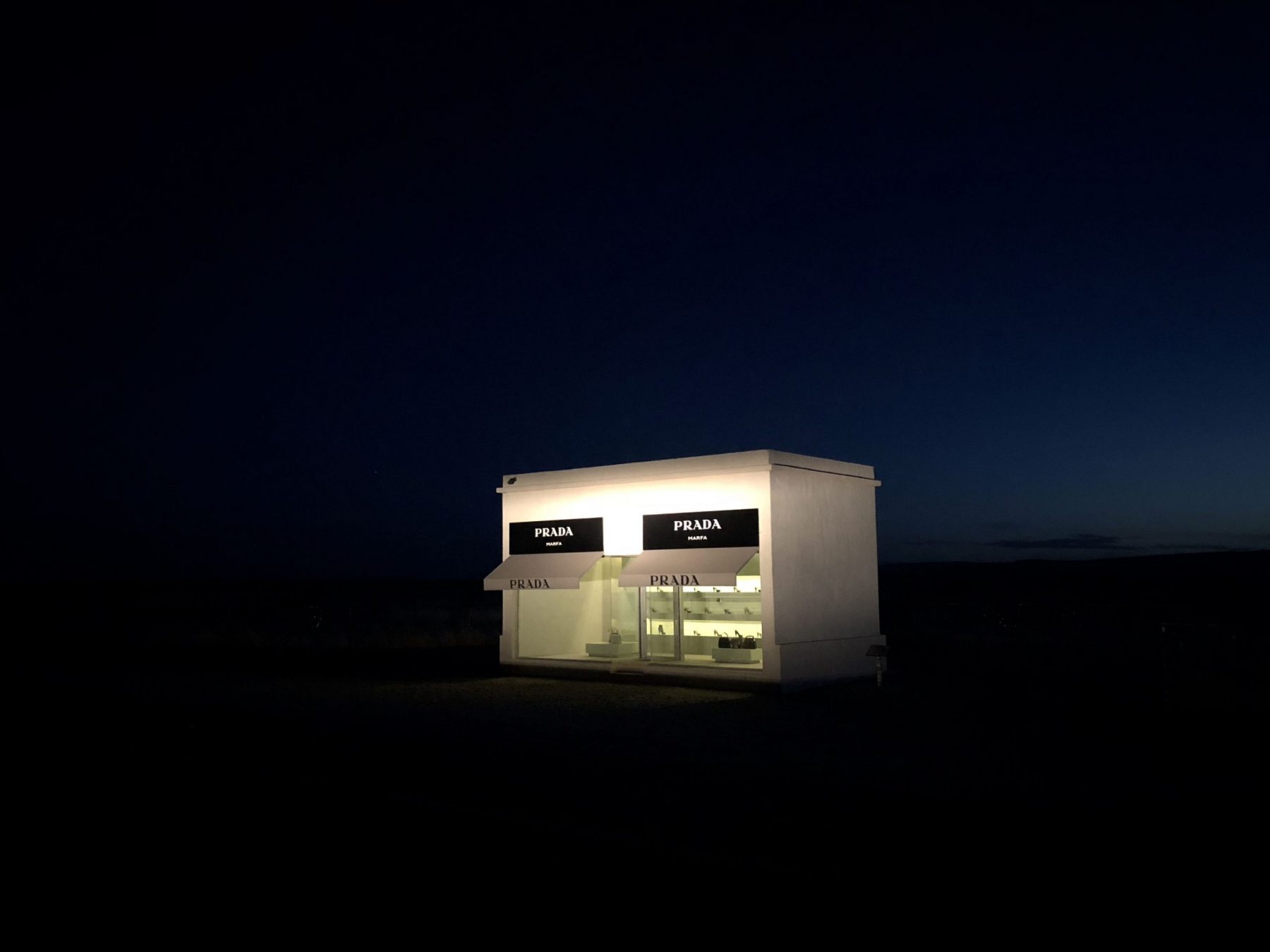 A photo of an illuminated building in total darkness