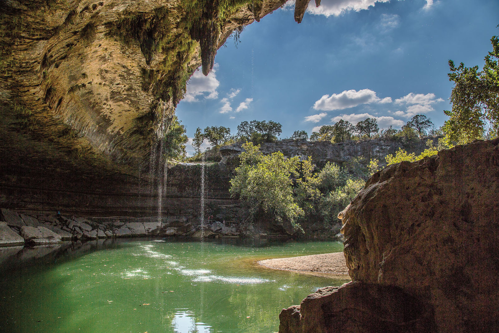 Blue sky and green water of Hamilton Pool