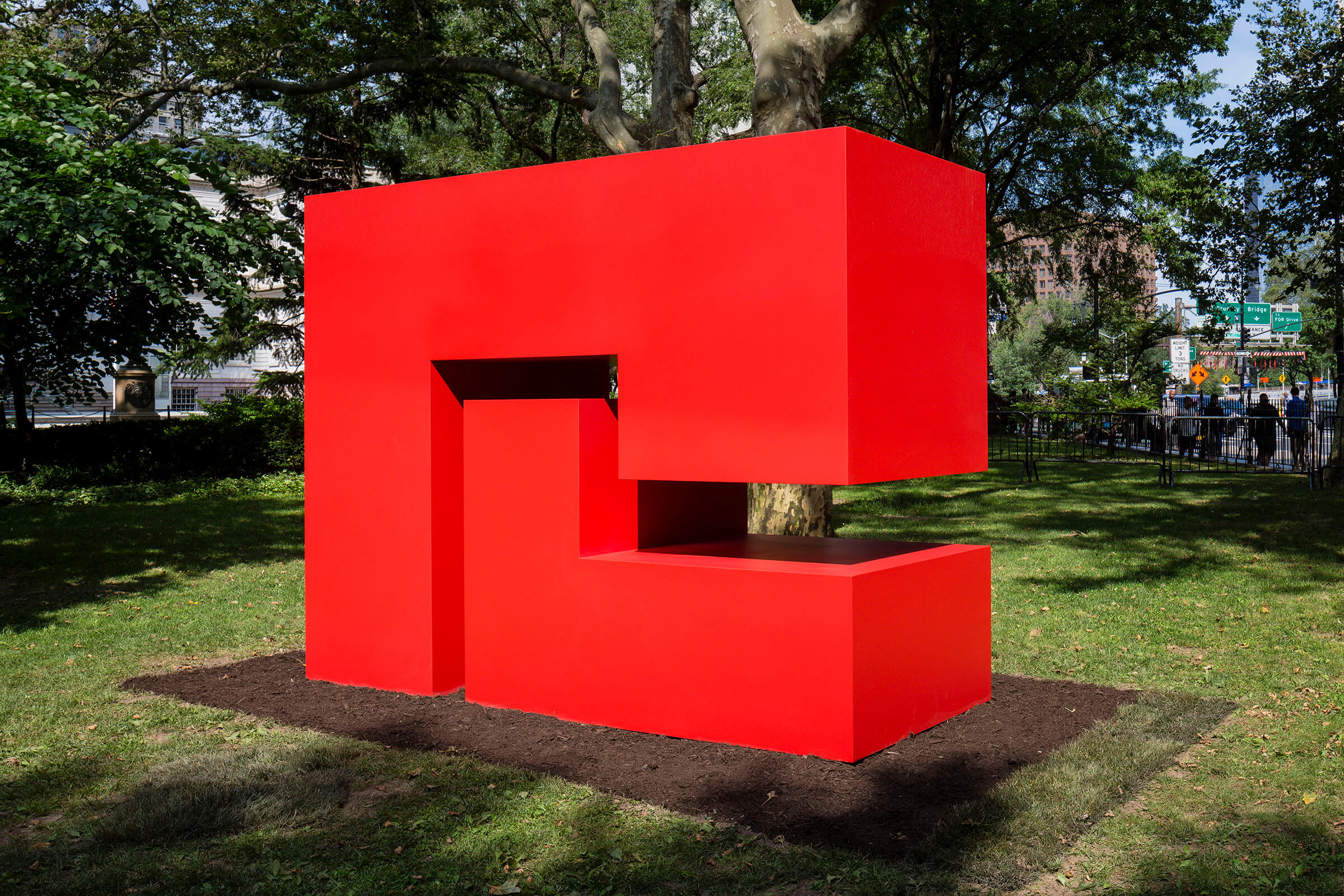 A red geometric statue by Carmen Herrera