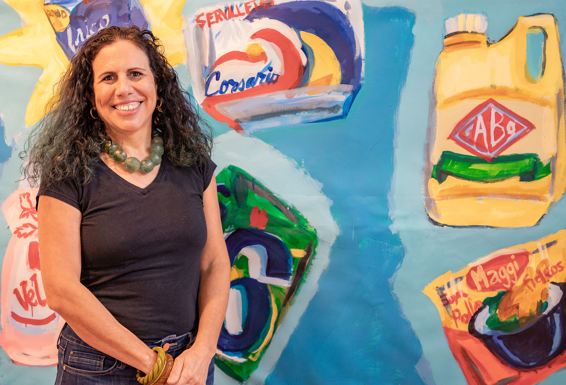 Artist Victoria Suescum stands in front of her artwork, which takes inspiration from tienditas in her McNay exhibition "Folk Pop." Photo courtesy McNay Art Museum.
