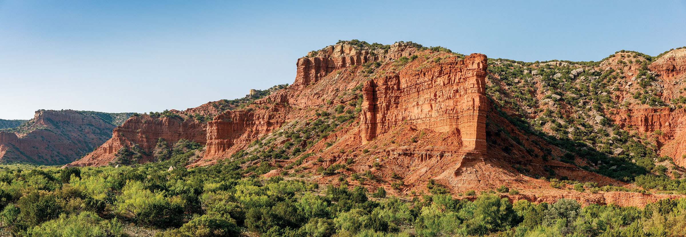 A panoramic view of the canyons and greenery of Caprock Canyons