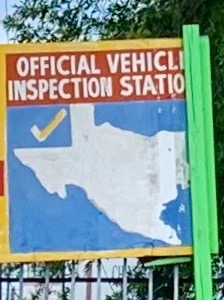 A state inspection sign hangs on a wall at a mechanics shop on Bellaire Boulevard in Houston. 