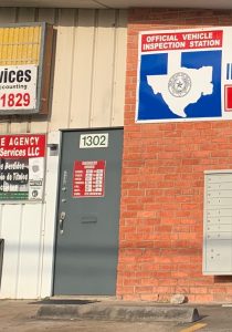 A state inspection signs hangs on the wall of a mechanics shop on South Post Oak Road in Houston. 