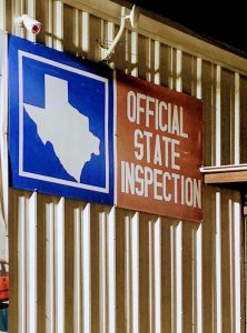 A state inspection sign hangs on a wall at a mechanics shop on North Shepherd Drive in Houston.