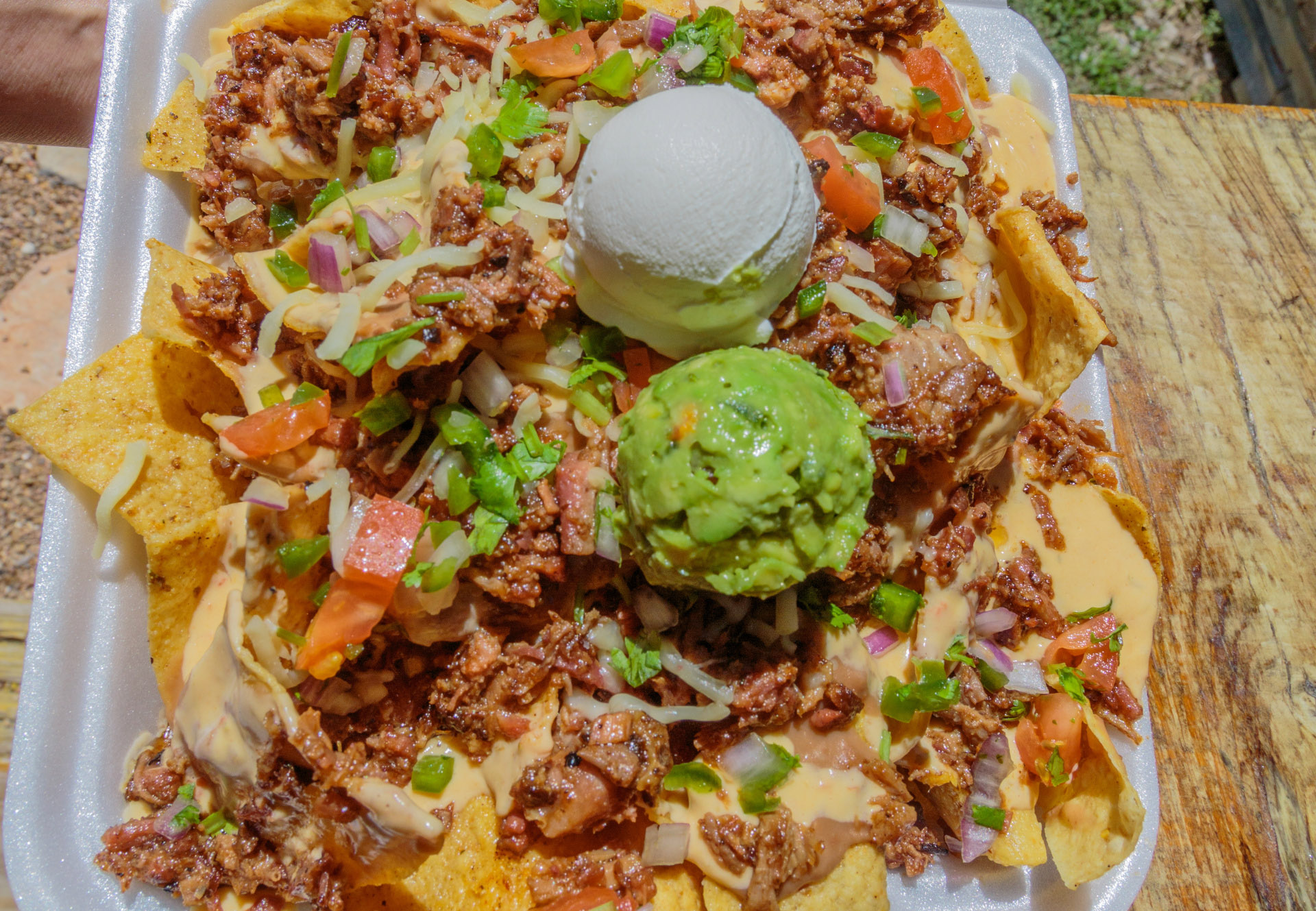 Nachos with scoops of guacamole and sour cream. Photo by Will van Overbeek.