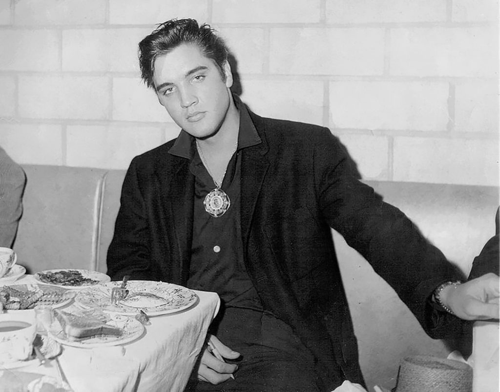 Elvis Presley sitting at a table at Little Shamrock Cafe in Cleveland.