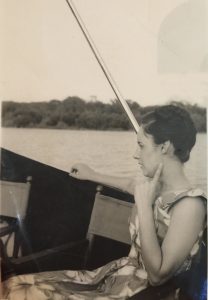 Black and white photo of a woman on a boat