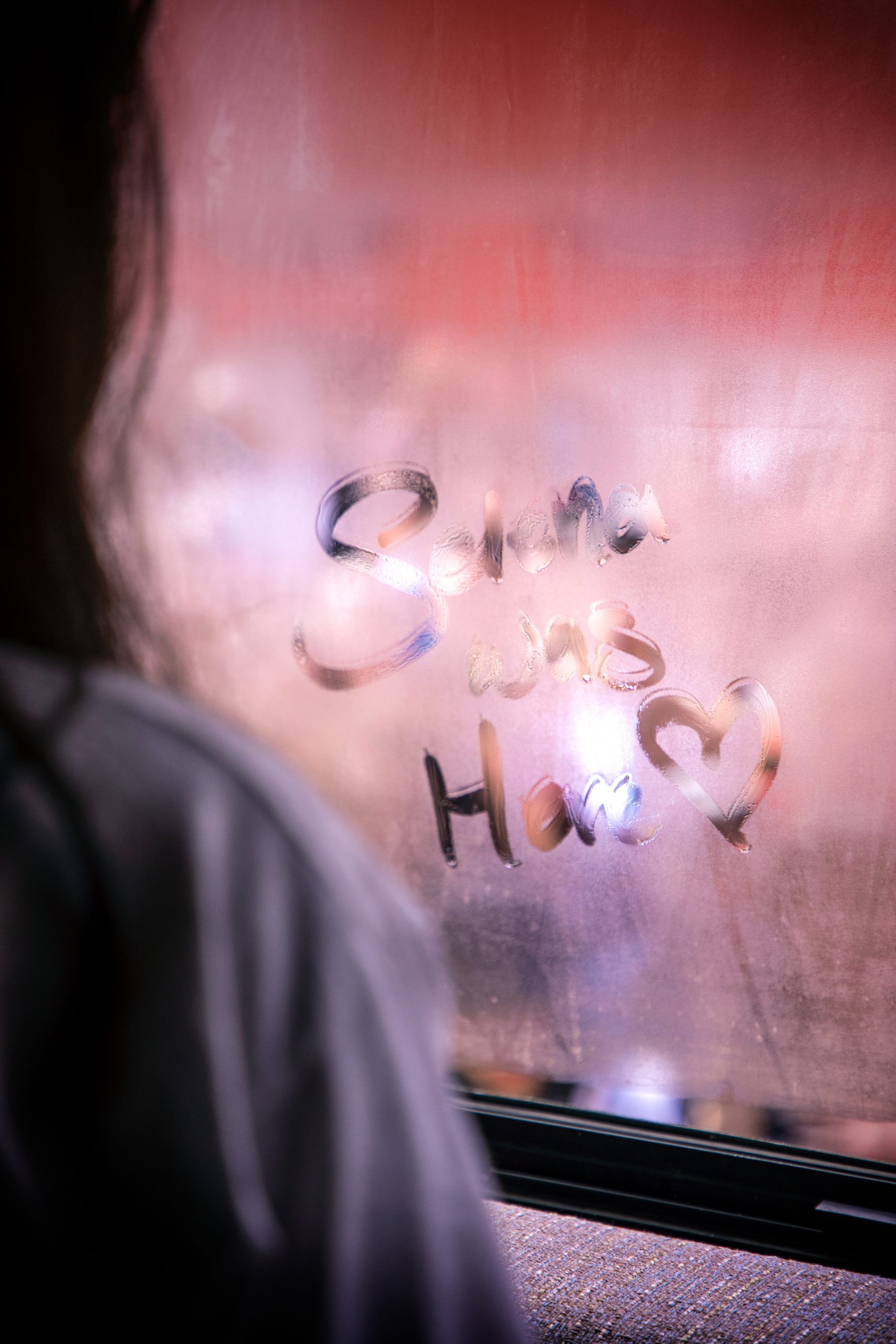 Photo of a steamy window with letters