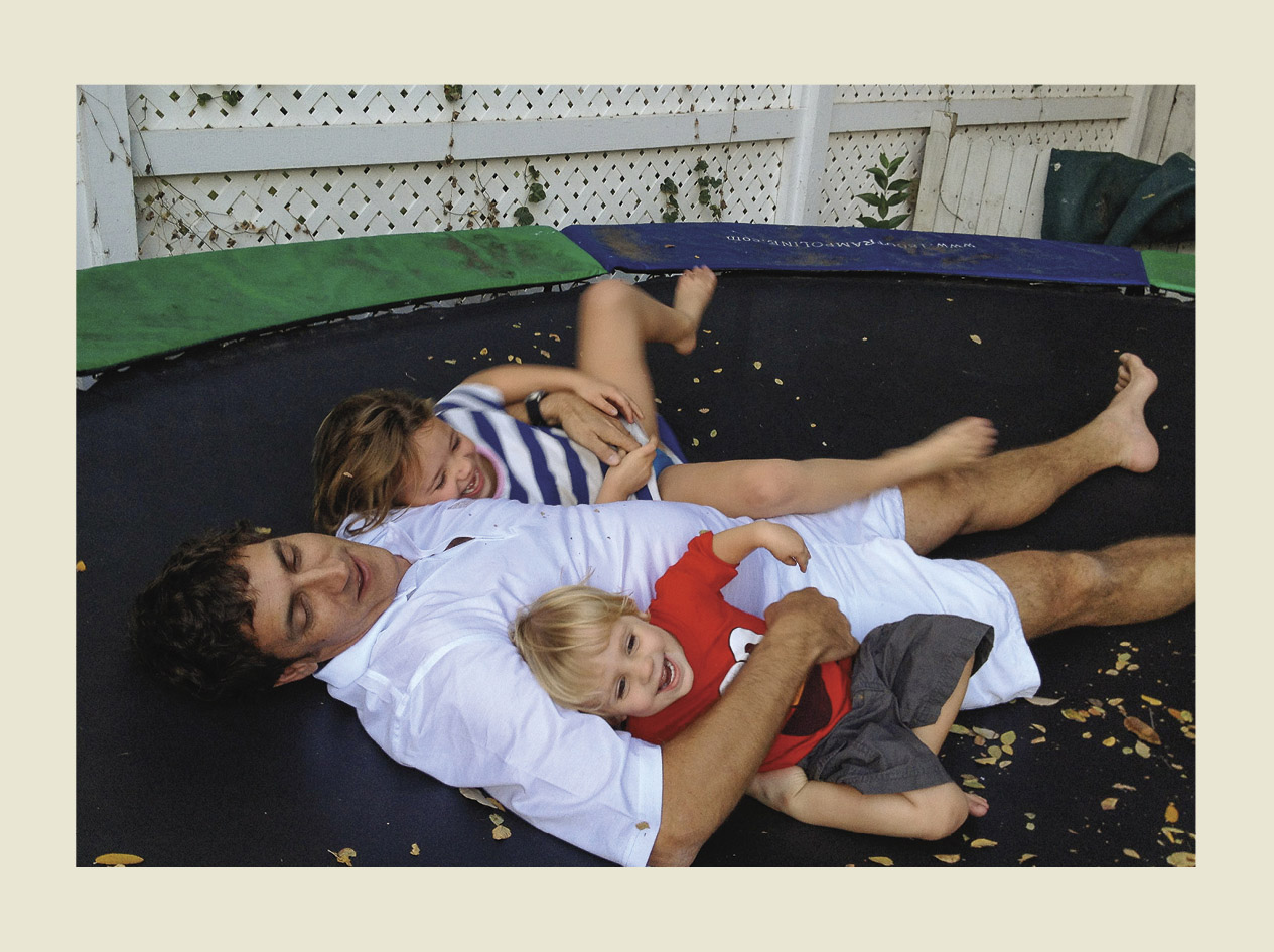 A family laying on a trampoline