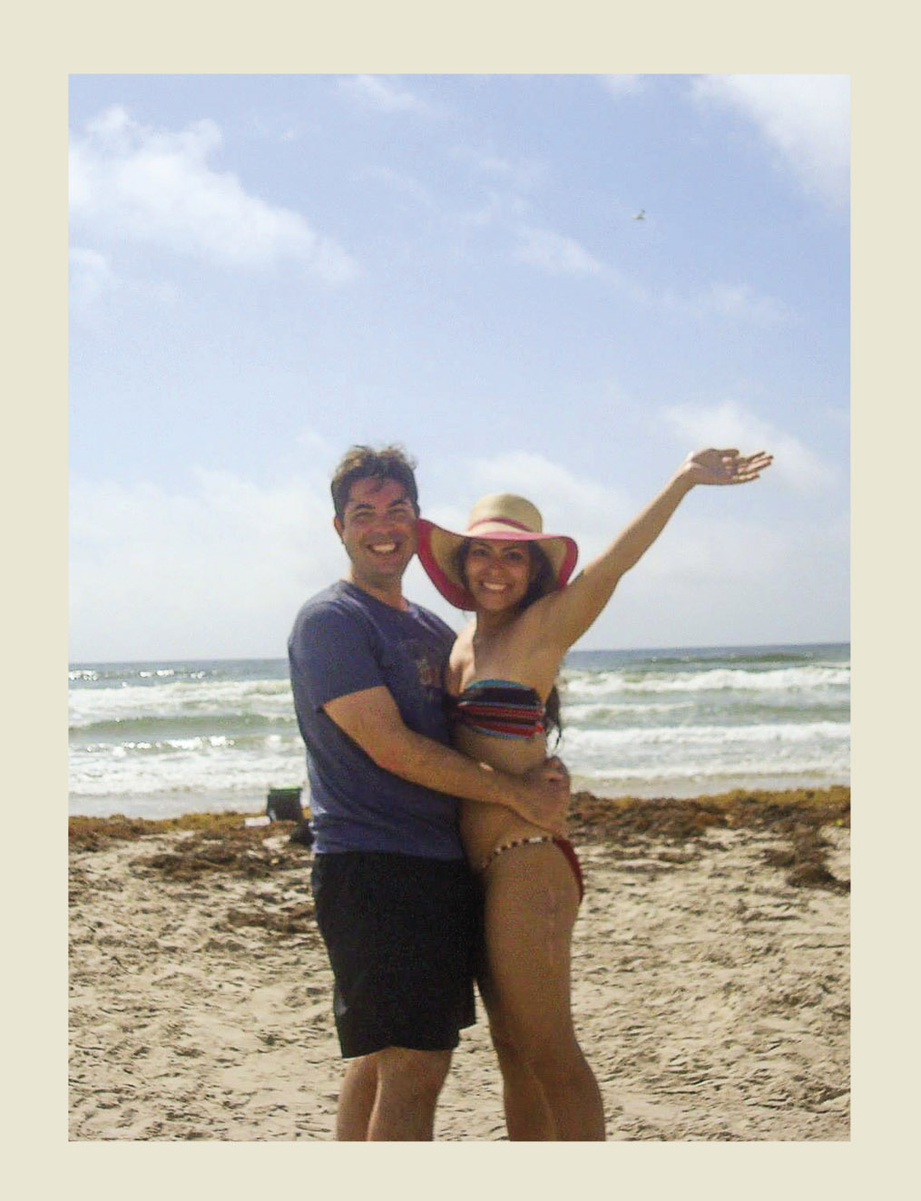 A man and woman standing on the seashore