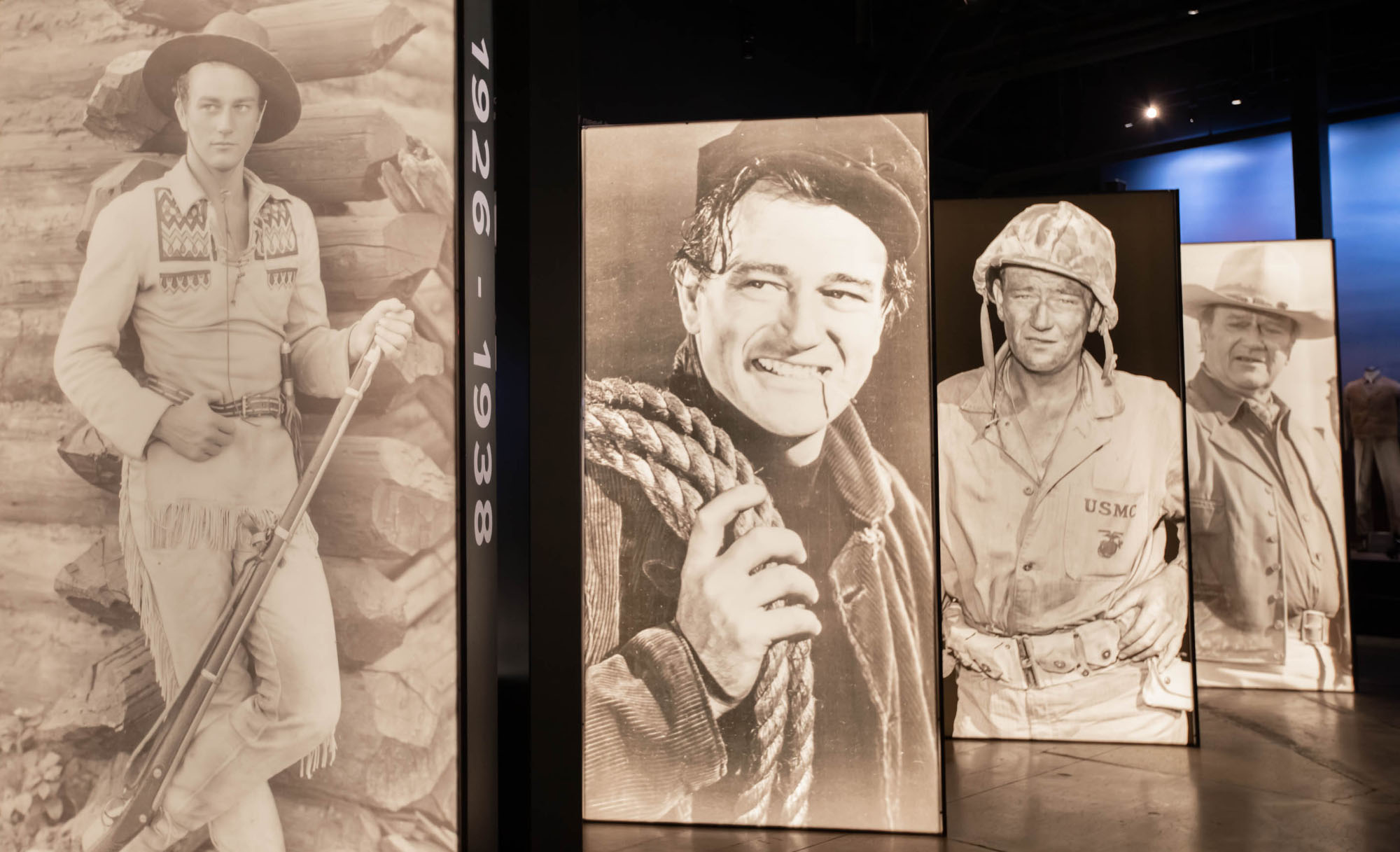 Posters of actor John Wayne in different movie roles line a section of the exhibition at the Fort Worth Stockyards. 