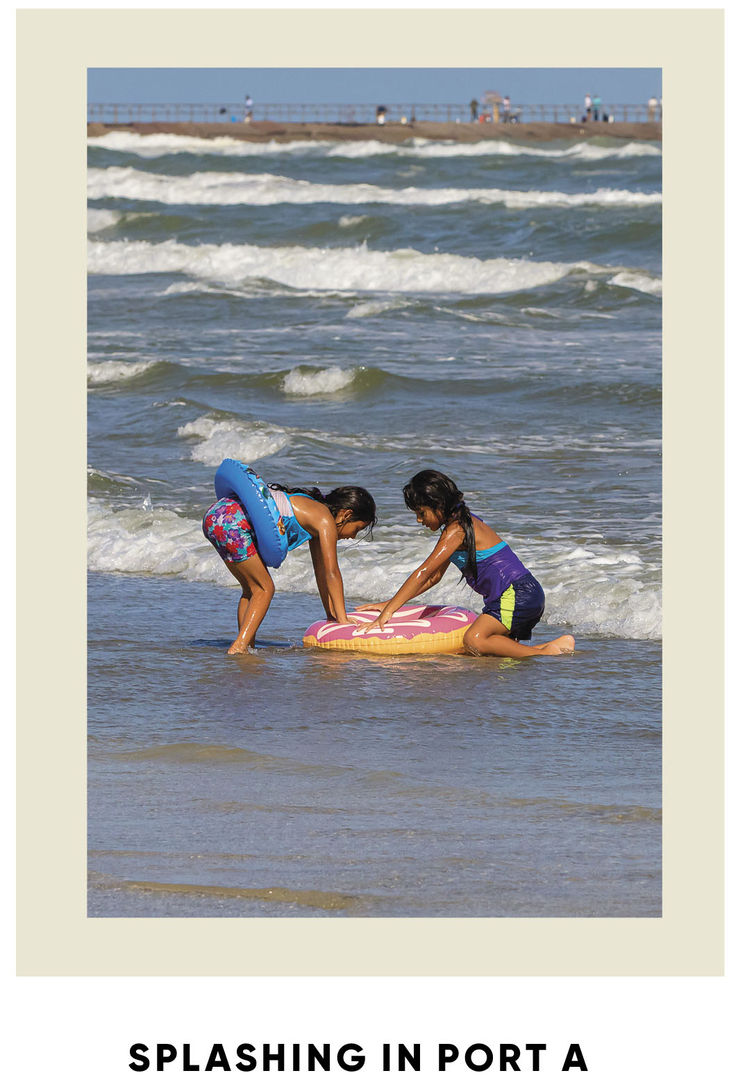Two kids play in the waves in Port Aransas