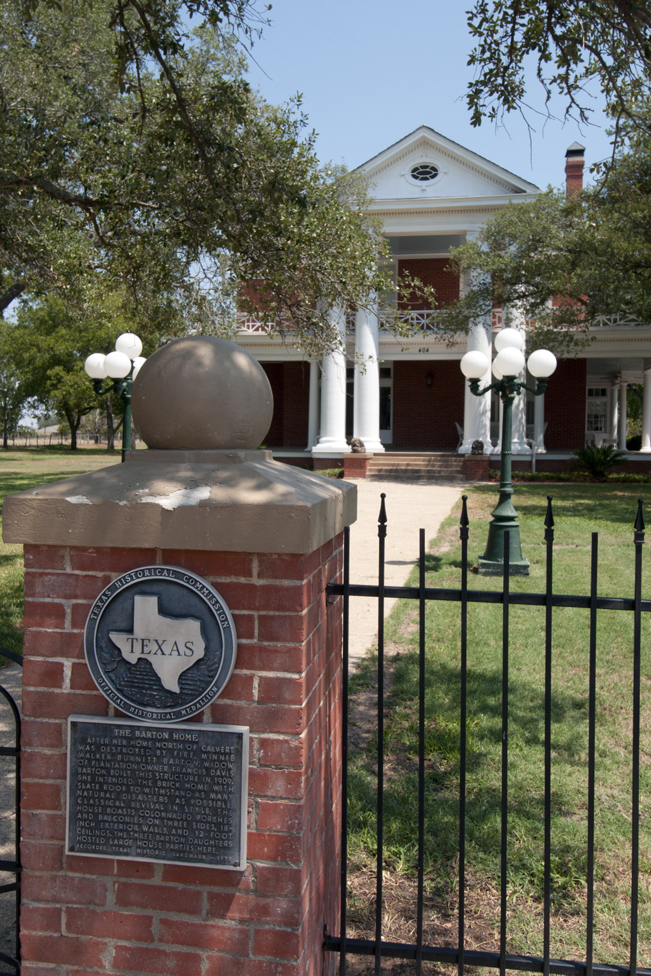 A brick pillar and Texas Historical Marker