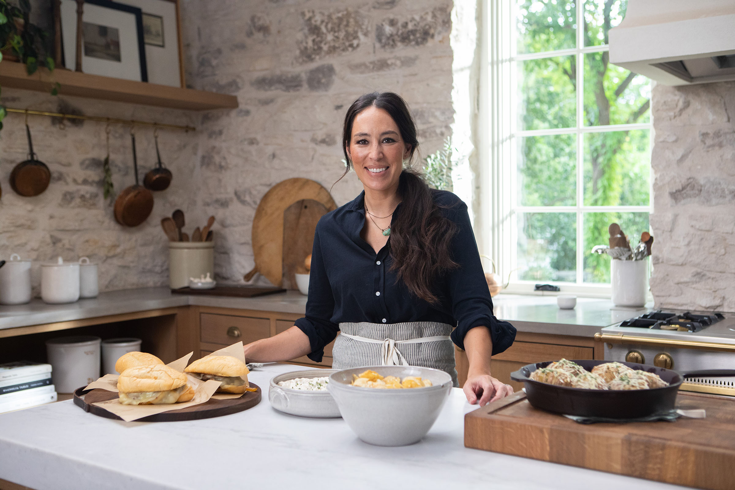 Fixer Upper host Joanna Gaines is pictured in her kitchen set for her new show Magnolia Table.