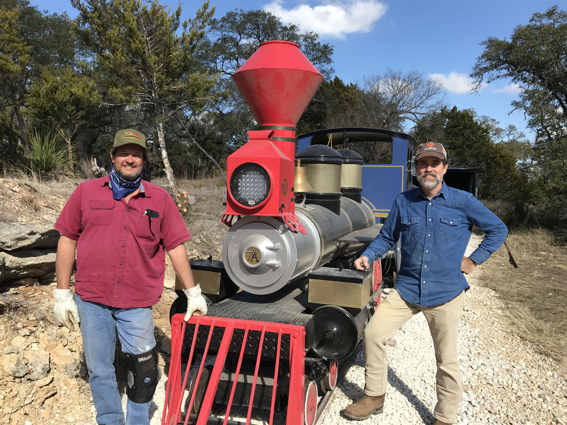 JC Herrera (standing left) and Scott Way stand with the 7A Resort's Pioneer Express they built together. Photo by Joe Nick Patoski. 