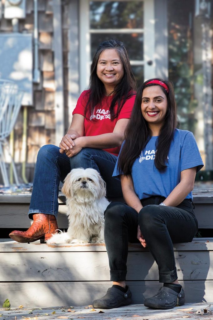 Hoa Tran and Dixya Bhattarai pose together the steps of a porch.