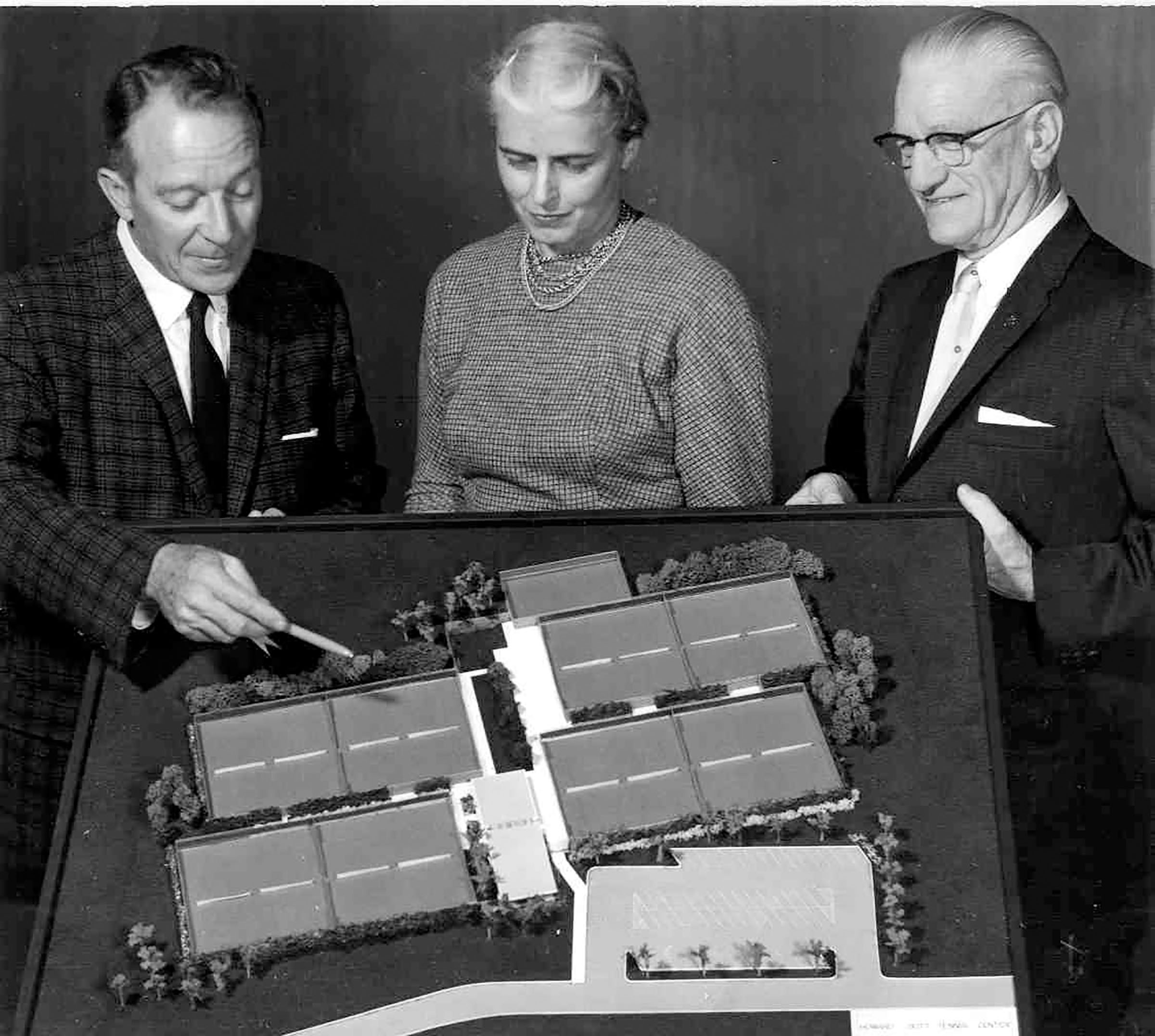 A black and white photo of Howard E. Butt Sr. (right) and his wife, Mary, looking over plans for the new H-E-B Tennis Center in Corpus Christi. Photo courtesy the Texas Tennis Museum and Hall of Fame. 
