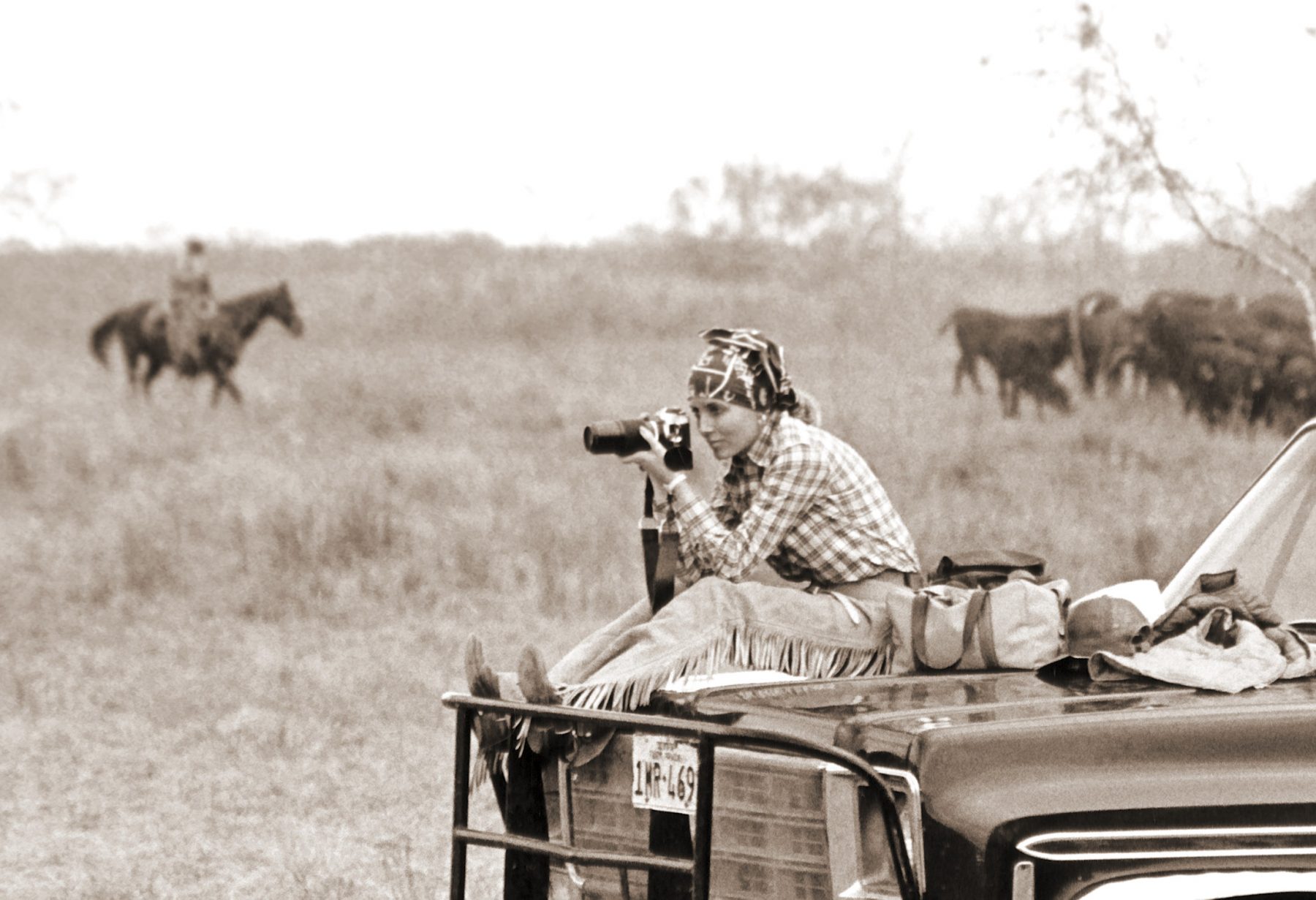 Black and white photo of a woman on a truck