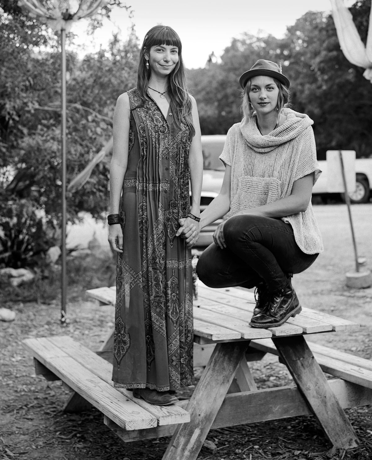 Two women sit on a picnic table