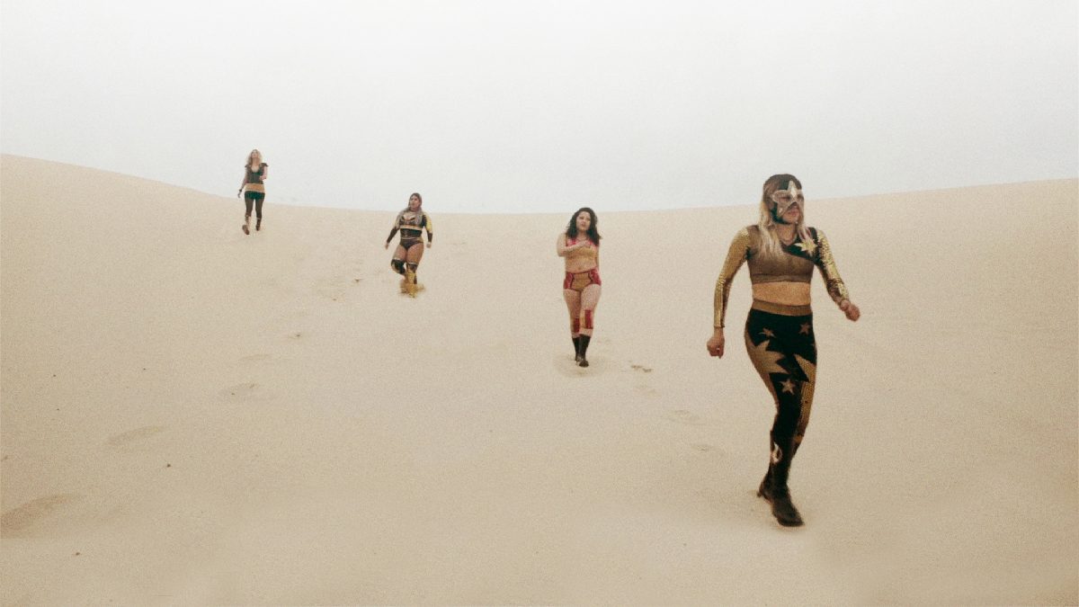 Color photograph of women on sand dunes