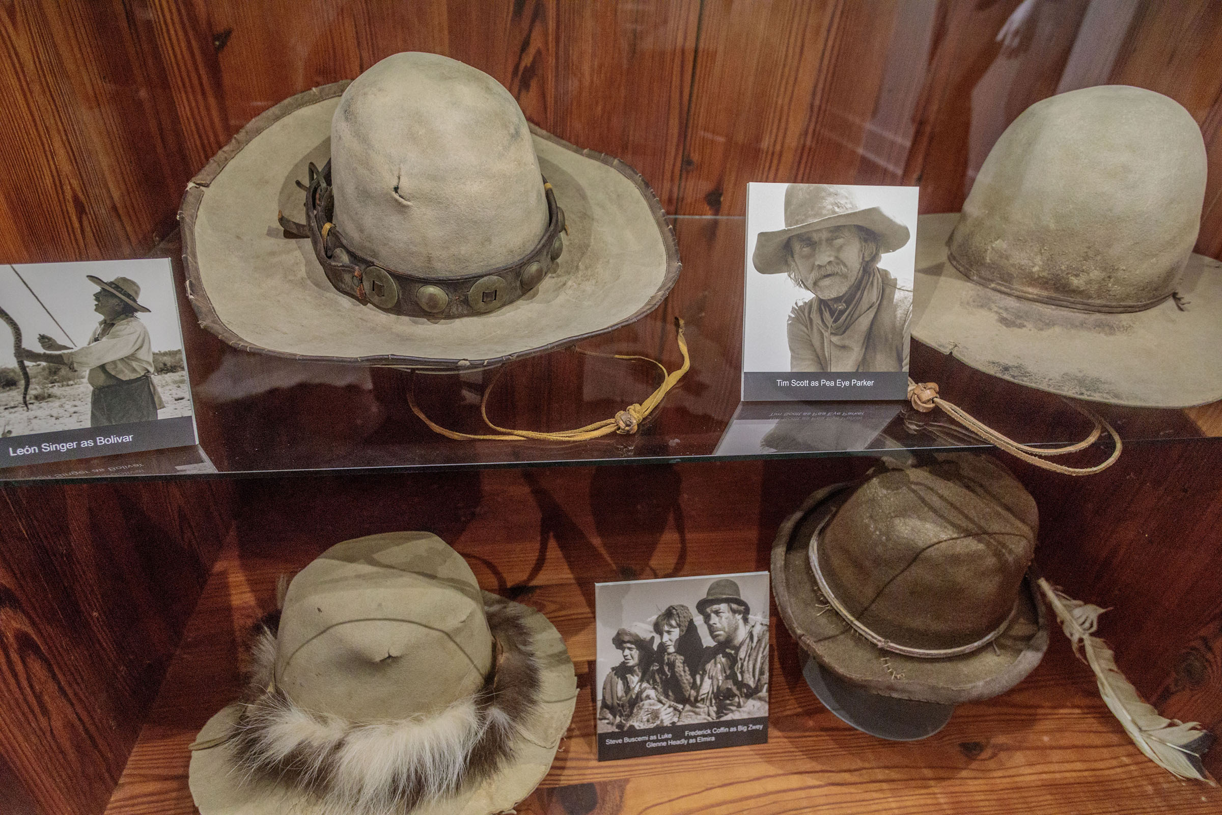 A collection of hats in a museum