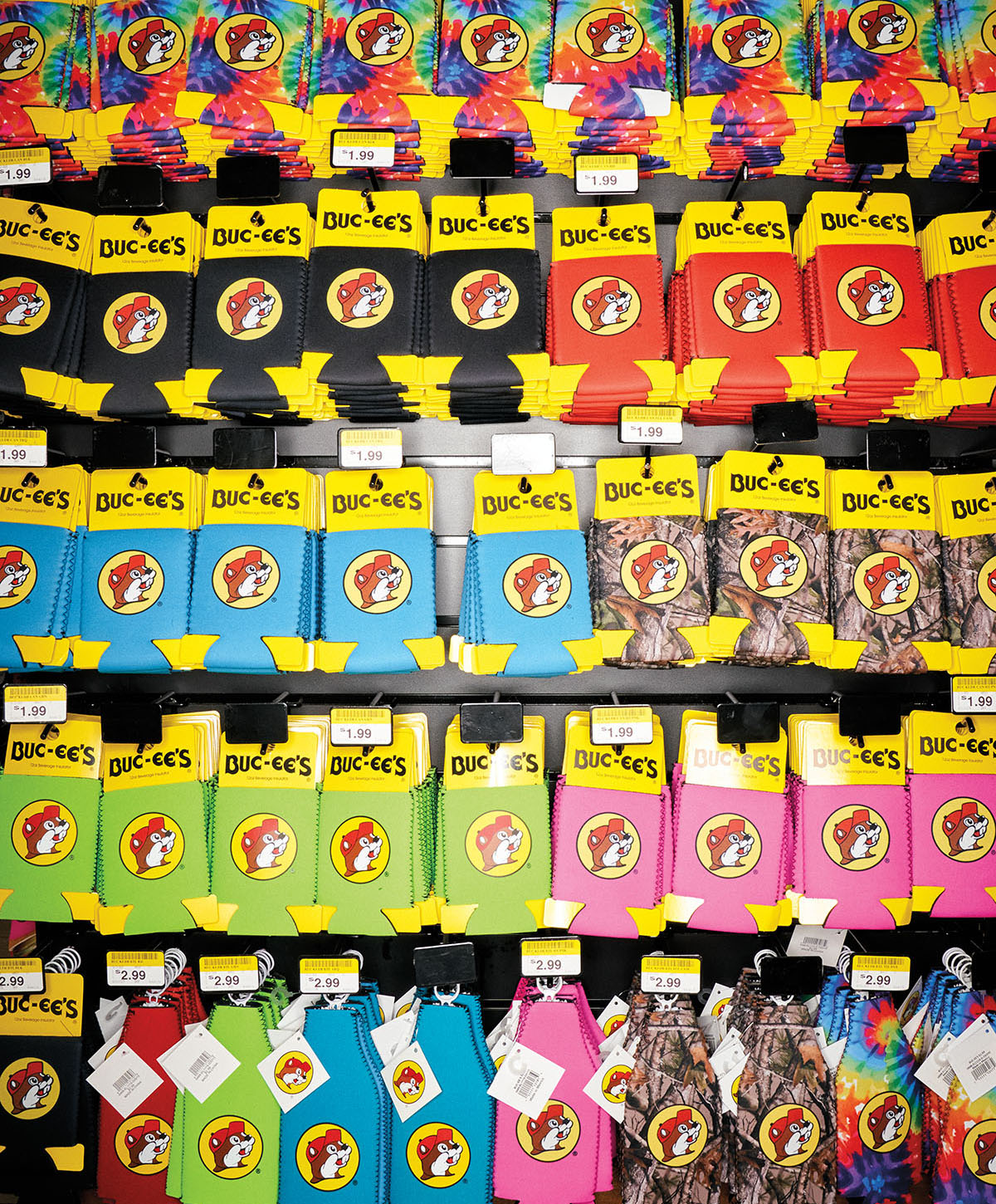 A wall of brightly colored, camo and neon drink holders (Koozies) with Buc-ee beaver