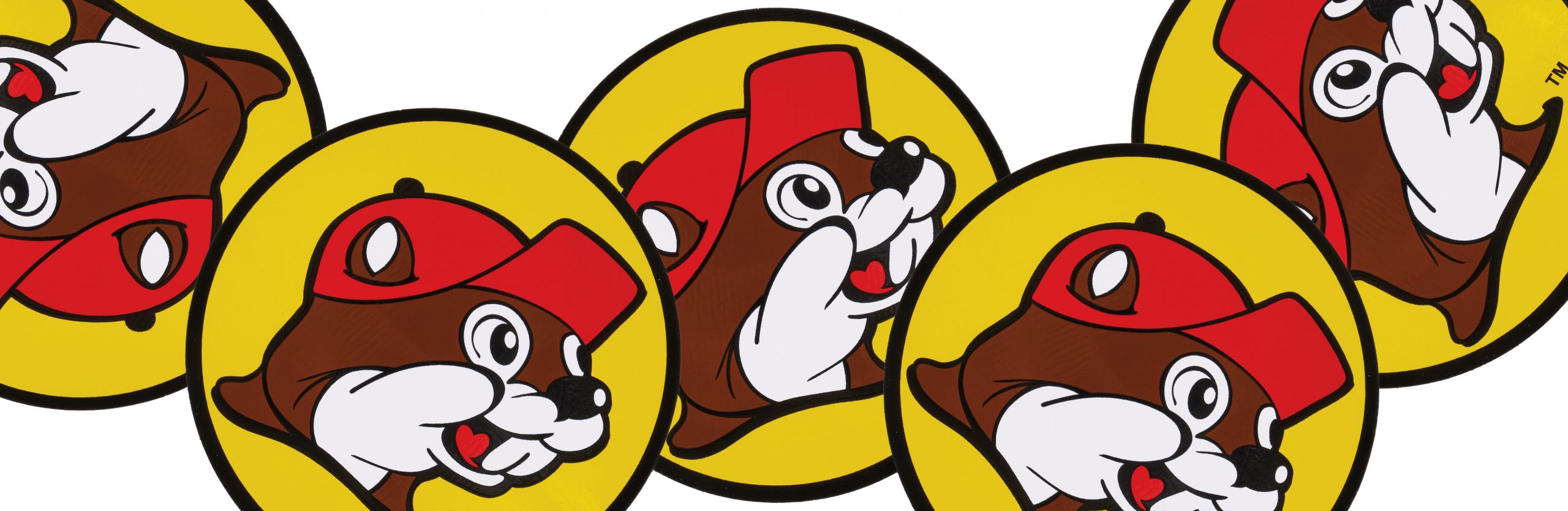 A collection of bright yellow bumper stickers with Buc-ee Beaver