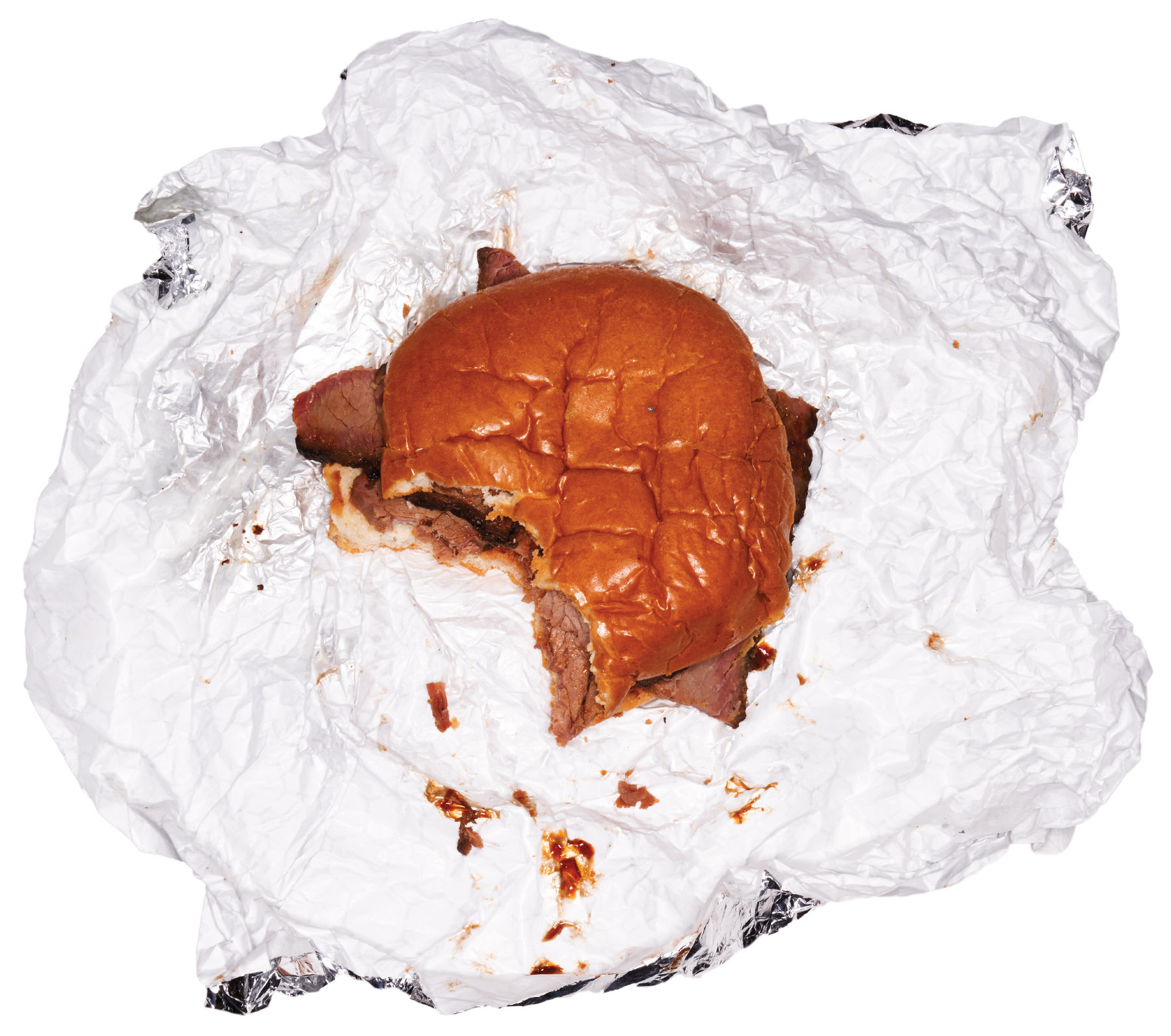 An overhead view of a brisket sandwich on a white wrapper