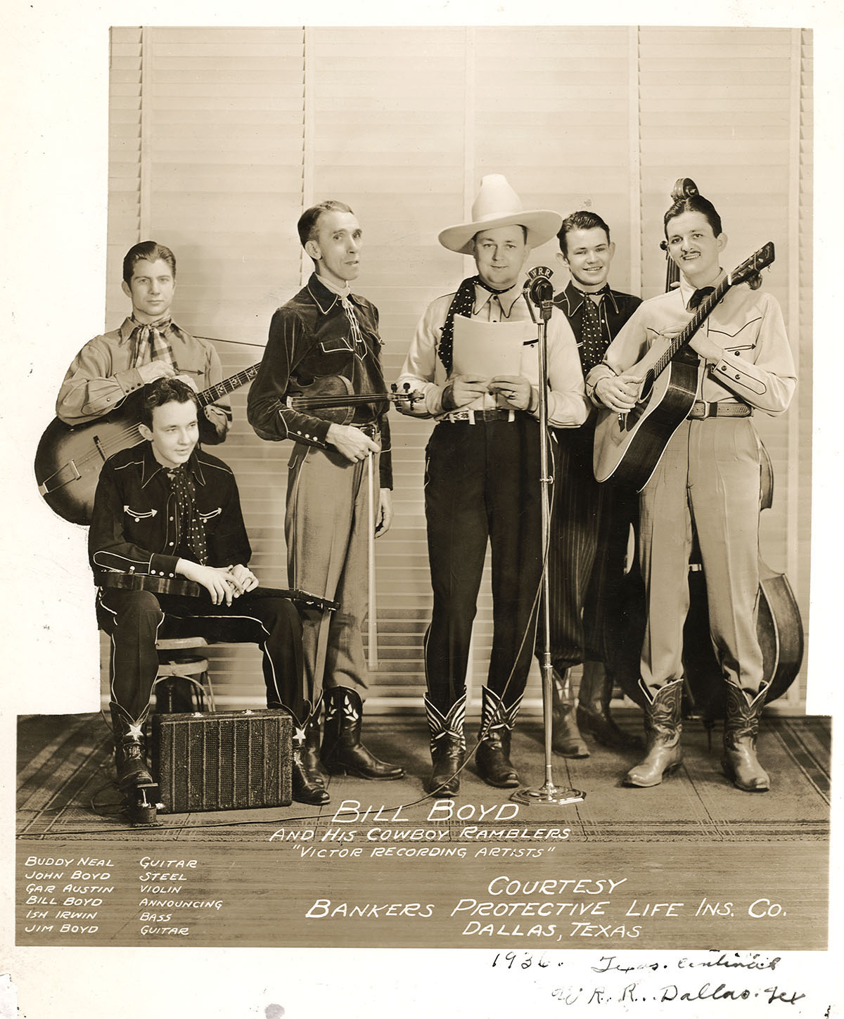 A group of men in hats holding guitars and standing at microphones