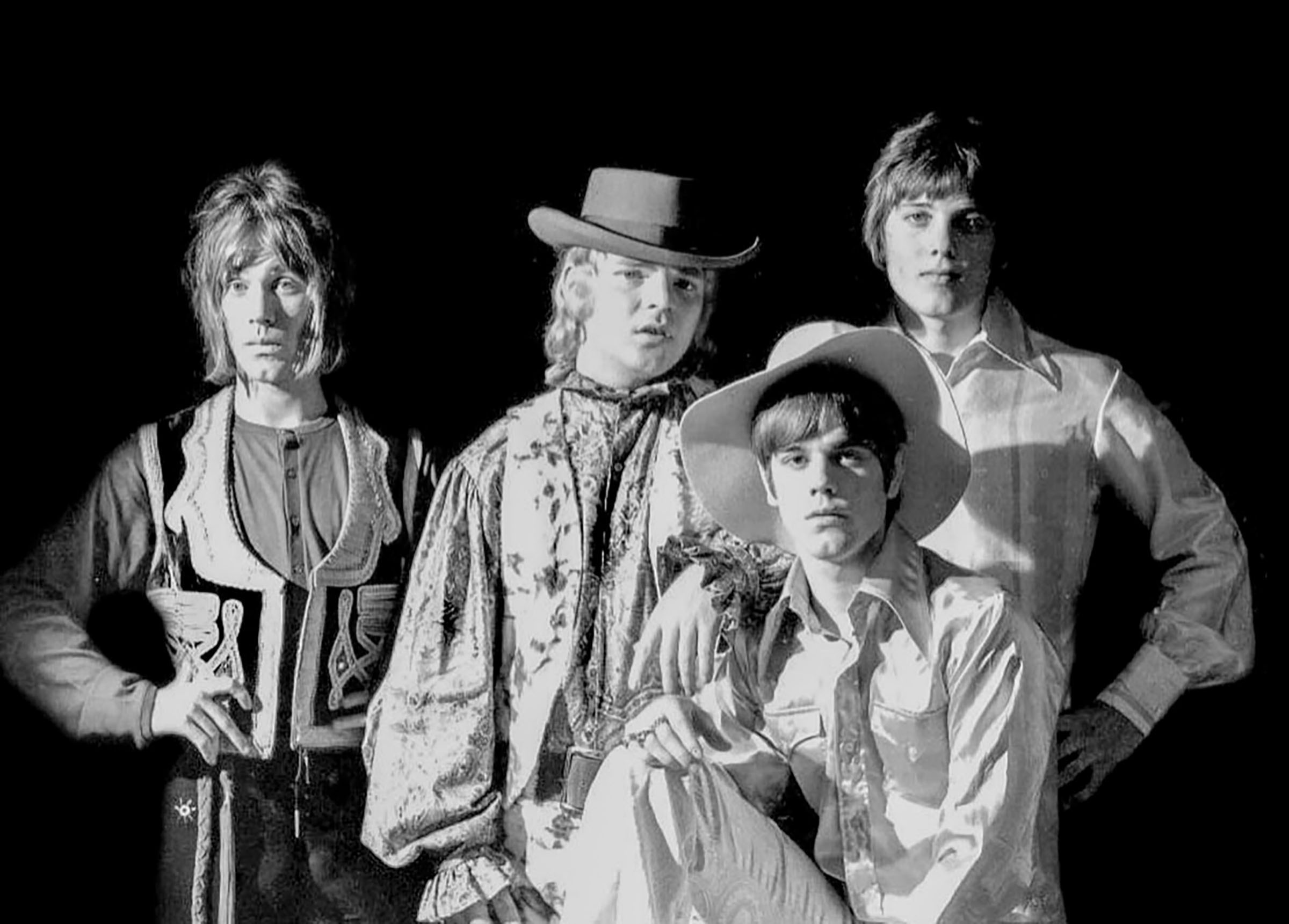 A black and white photo of a group of young men in western wear