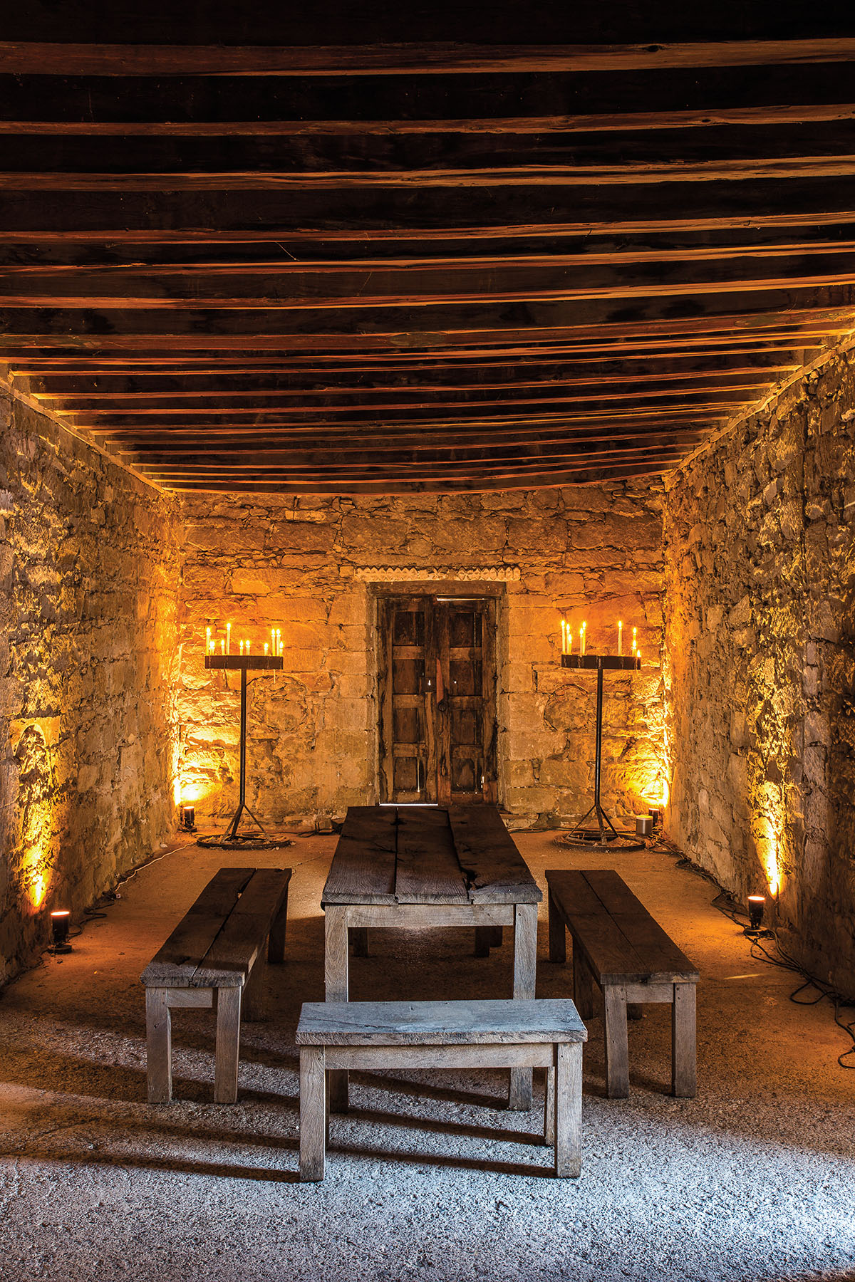 The candle-lit interior of a stone building