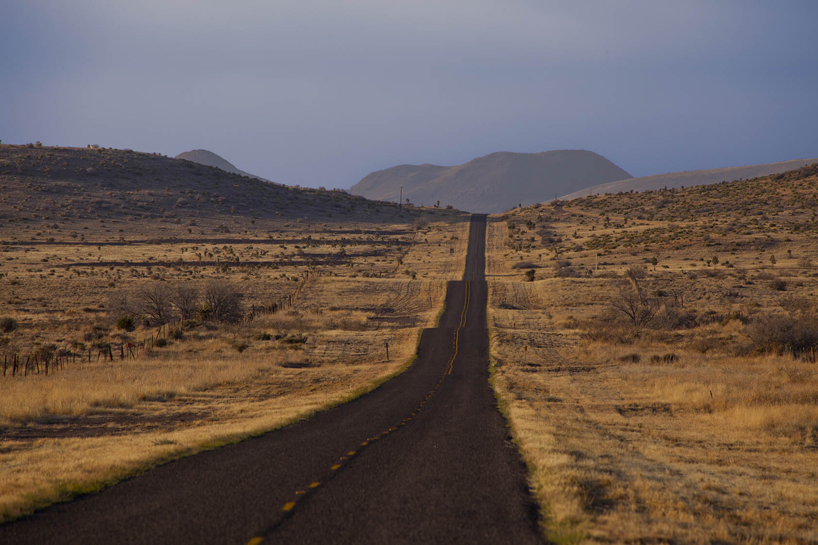 A stretch of highway runs up the middle of the image, with the Davis Mountains in the distance. Photo by Will van Overbeek