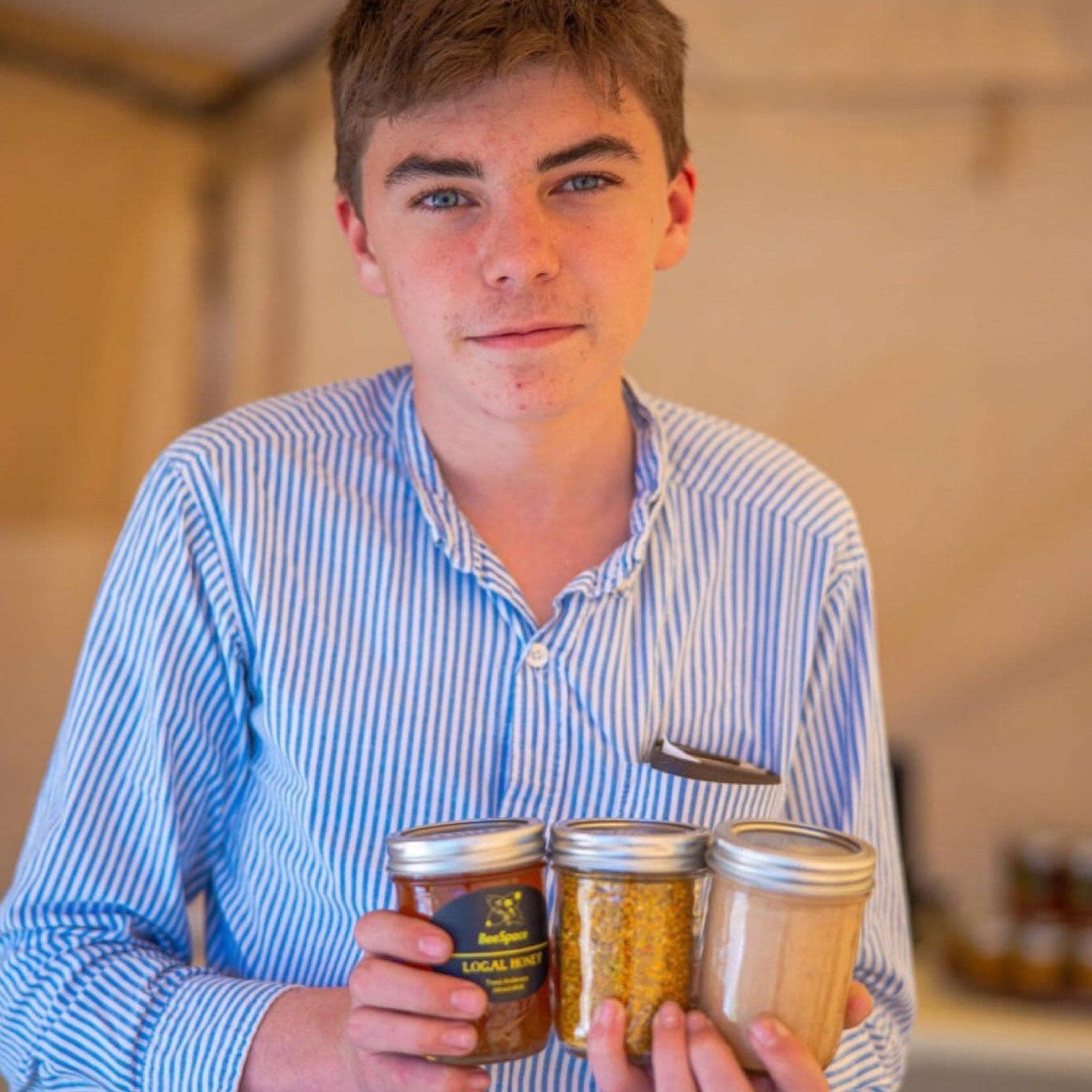 Trent Anderson, 16, holds jars of his locally made honey, which is sold in Castroville. 