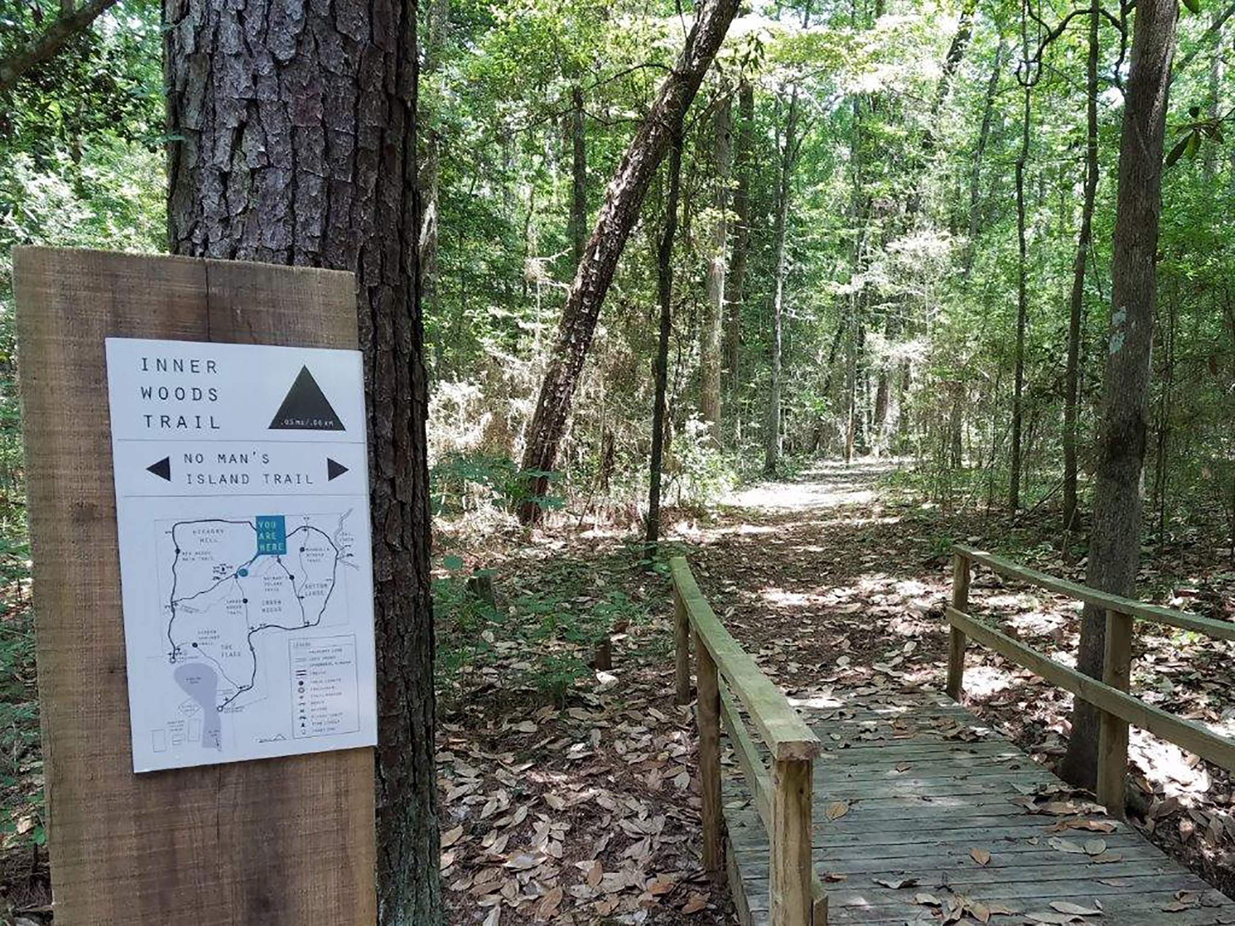 One of the new signages that help visitors navigate the five trails in the Big Woods Nature Trail marks a spot in front of a small bridge on the trail. Photo courtesy of the Tyler County Heritage Society. 