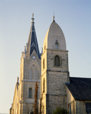 two churches stand side by side; steeple in foreground is in unusual Gothic style