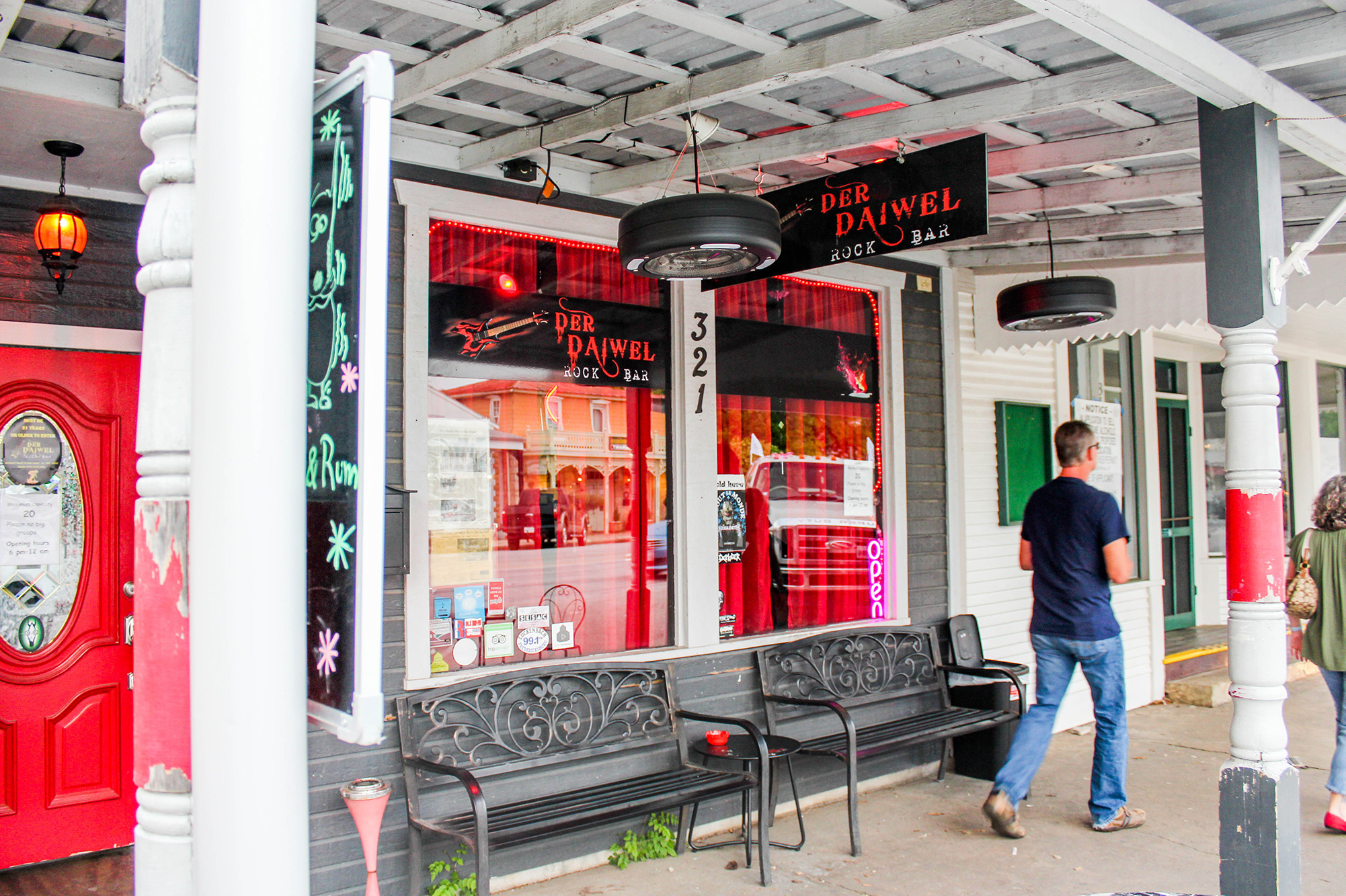 Der Daiwel's red and black storefront contrasts with Fredericksburg's white Main Street building