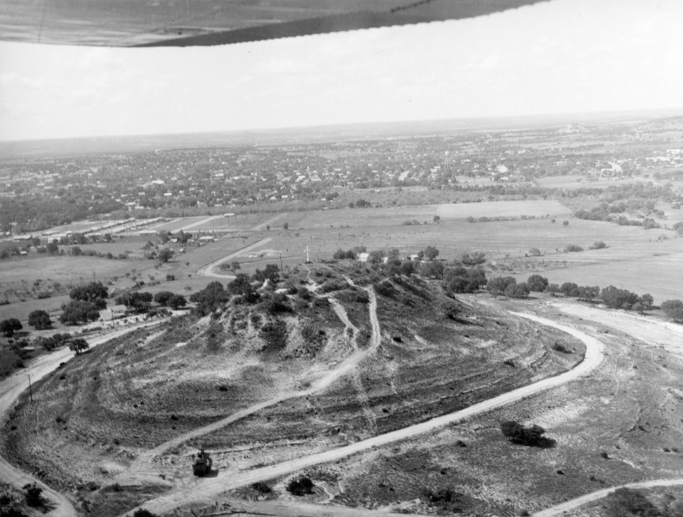 A picture from an airplane of a mound with a cross on it