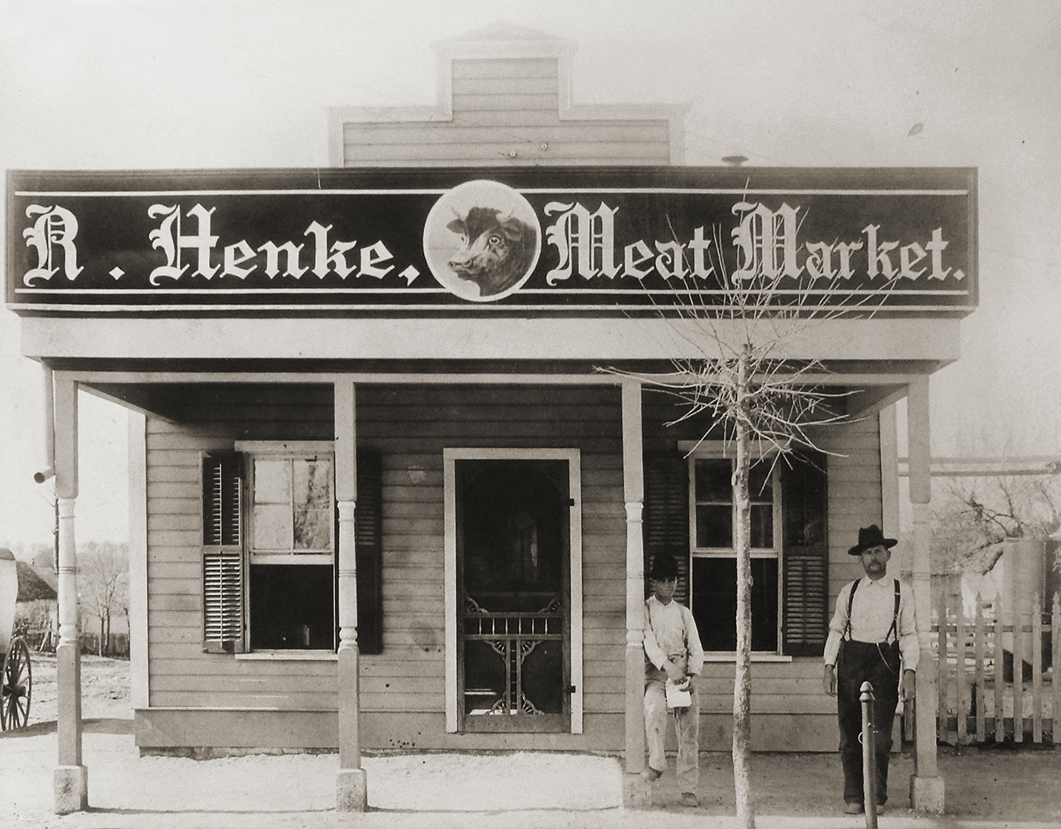 The outside of a shop with a sign reading R. Henke Meat Market