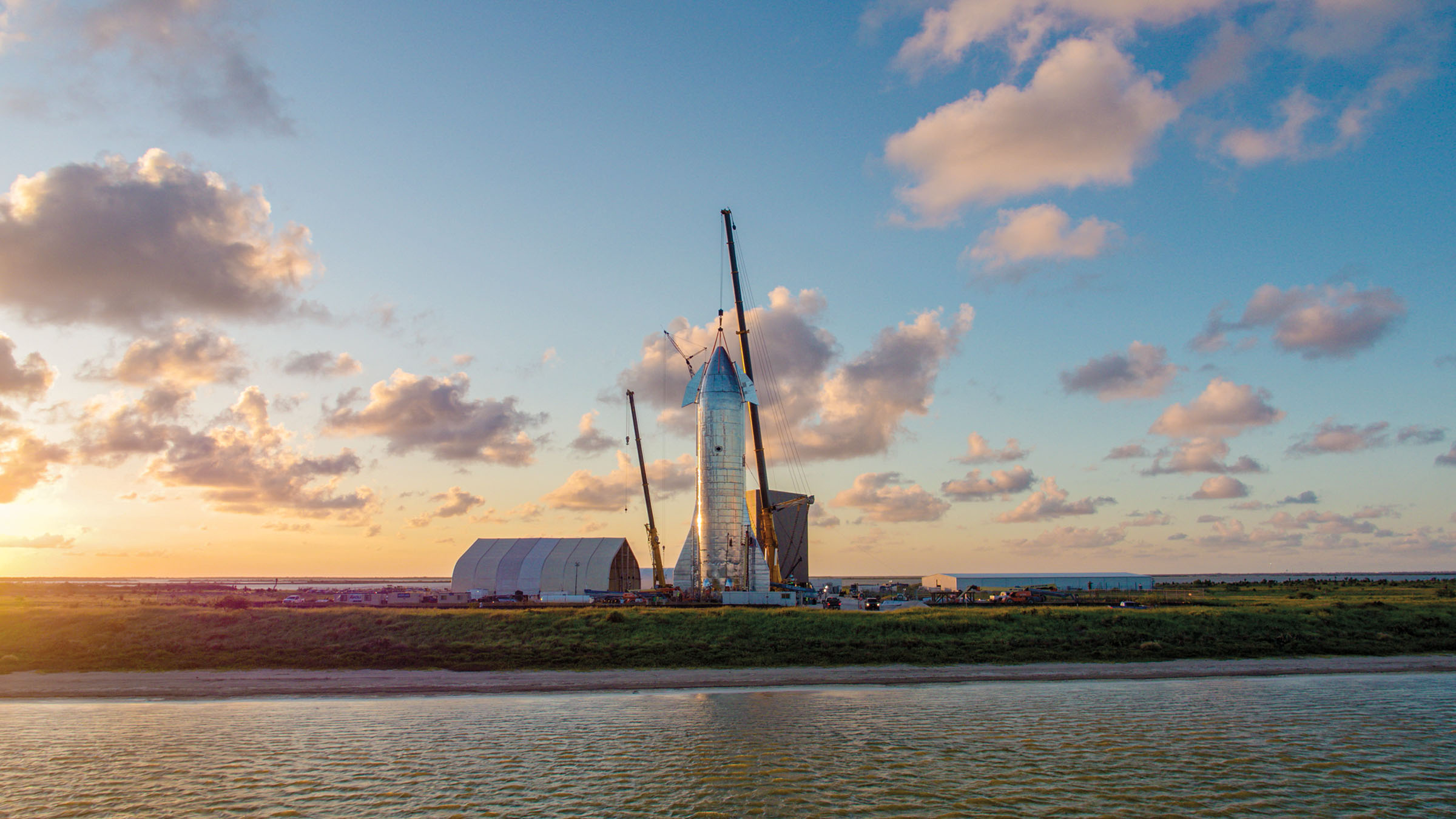 A rocket on a shoreline in a golden sunset